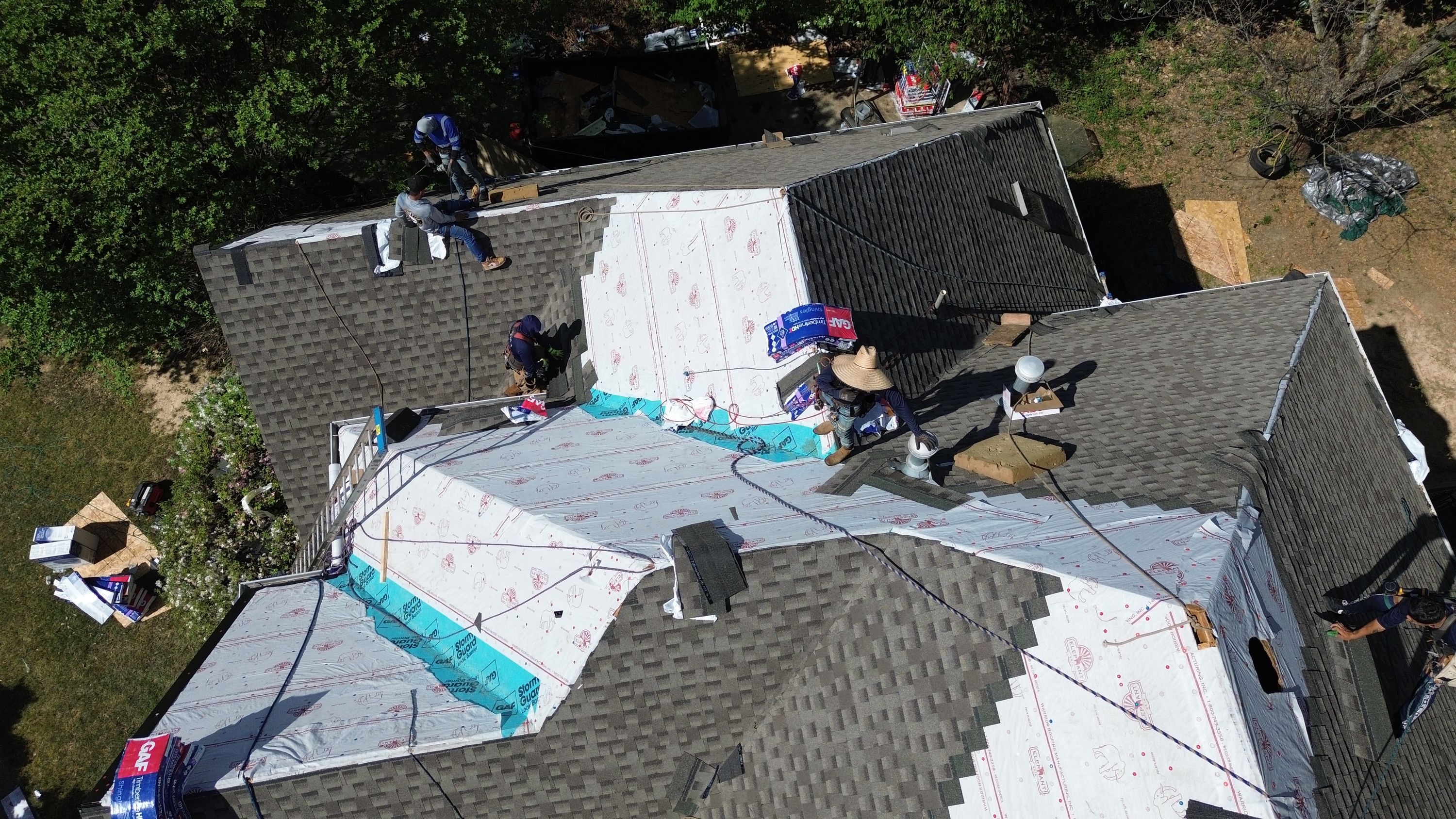 Patriot Roofing and Builders installing GAF underlayment and shingles during a Hoover roof replacement.