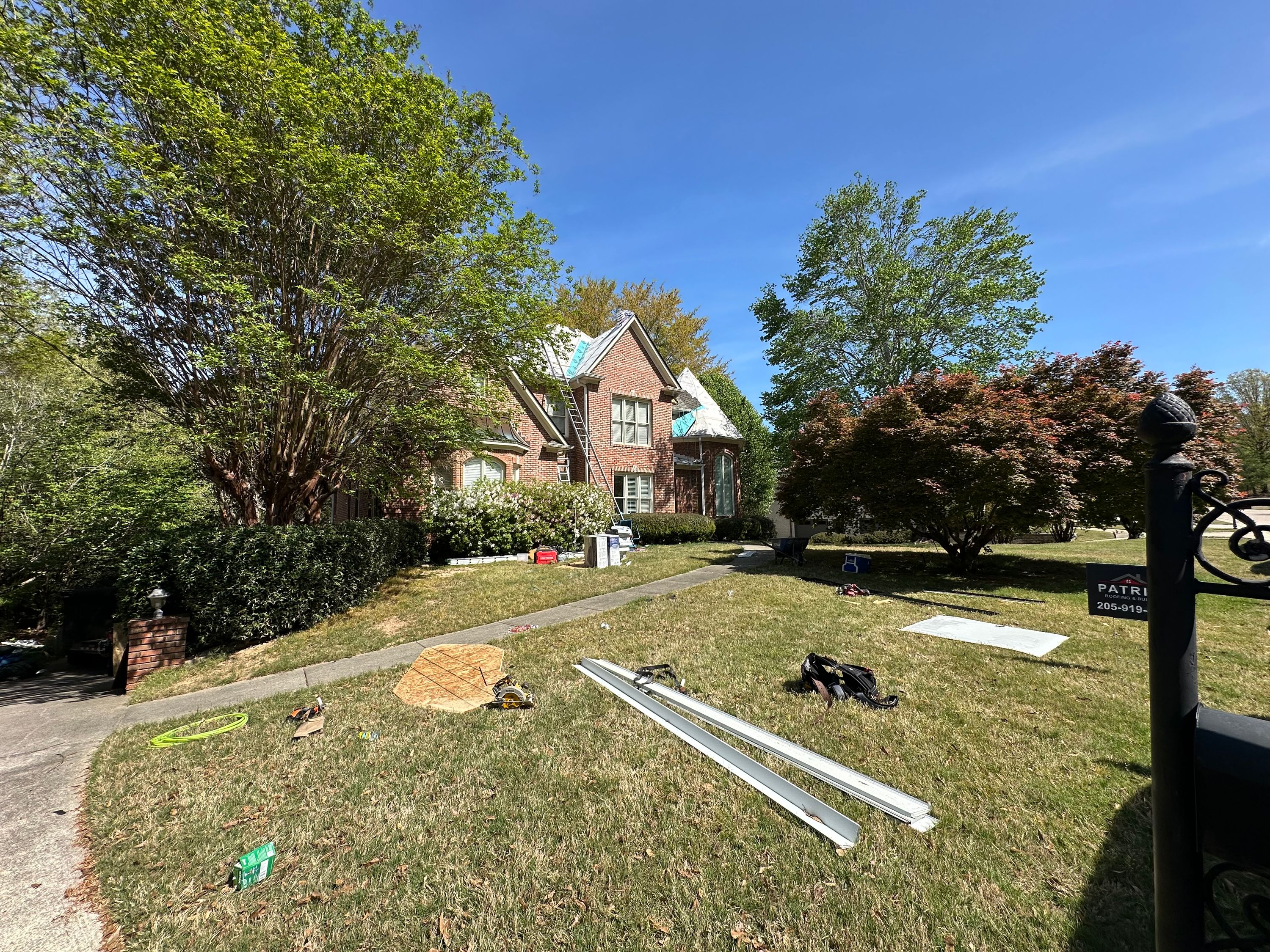 Patriot installs synthetic roof underlayment and stages aluminum gutters in Windchase.