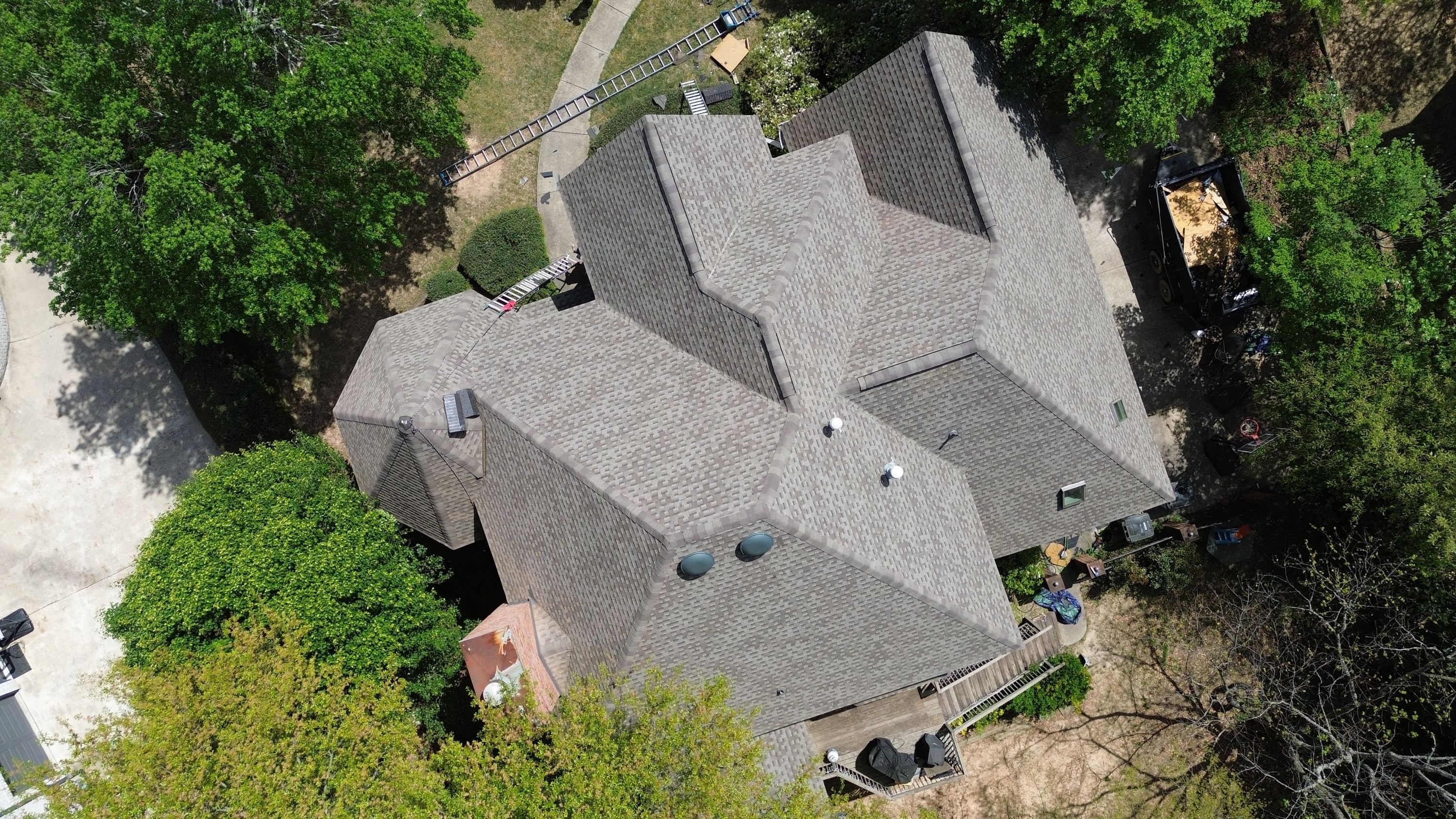 Patriot Roofing and Builders installed new architectural shingles and ridge caps on this multi-hip roof in Hoover.