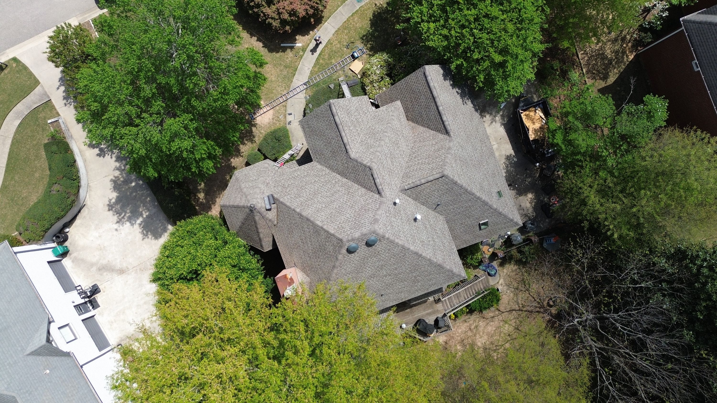 Aerial view of a hip roof replacement with architectural shingles by Patriot Roofing and Builders in Hoover.