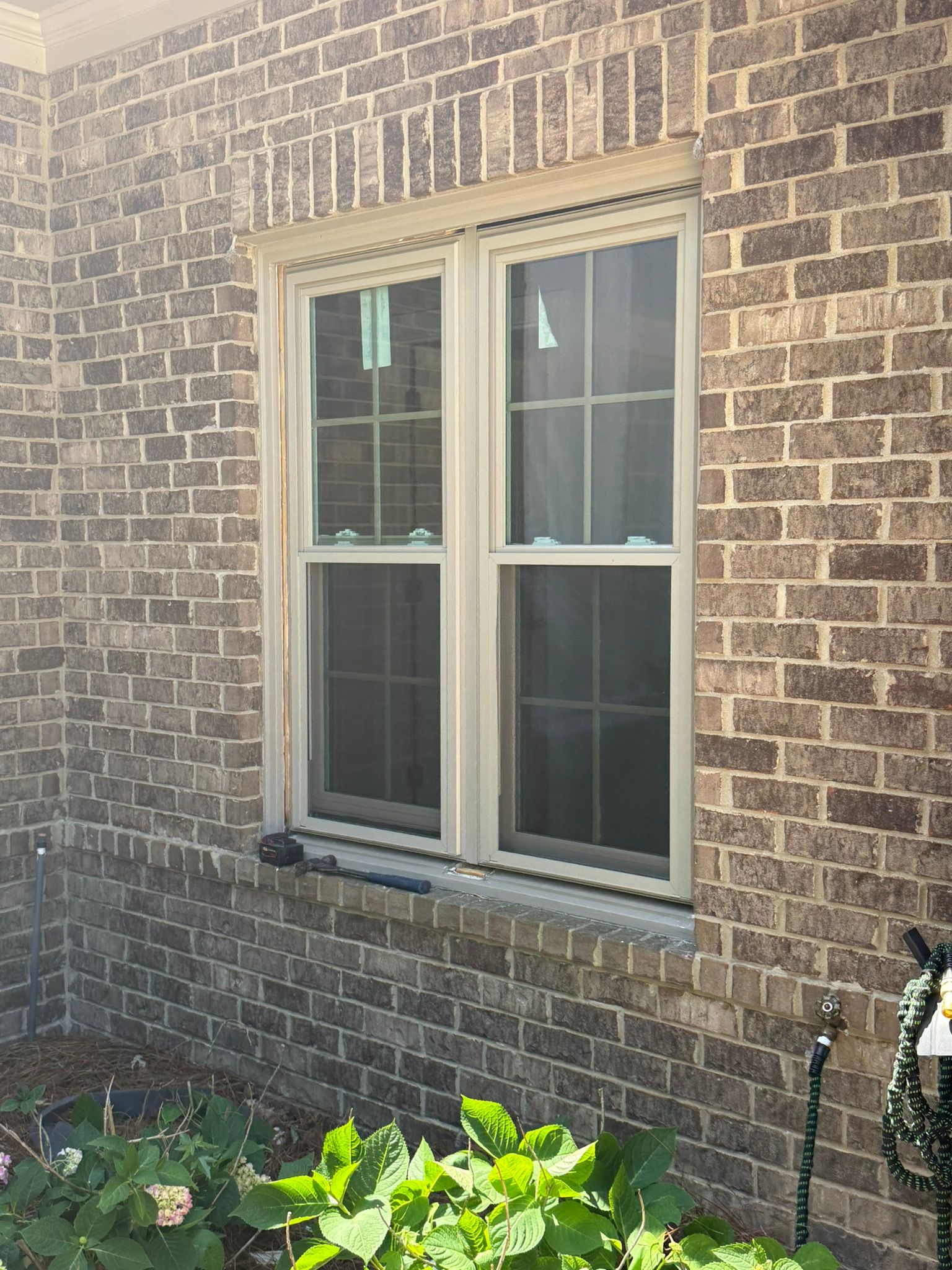 A newly installed double-hung window in a brick home in Bluff Park.