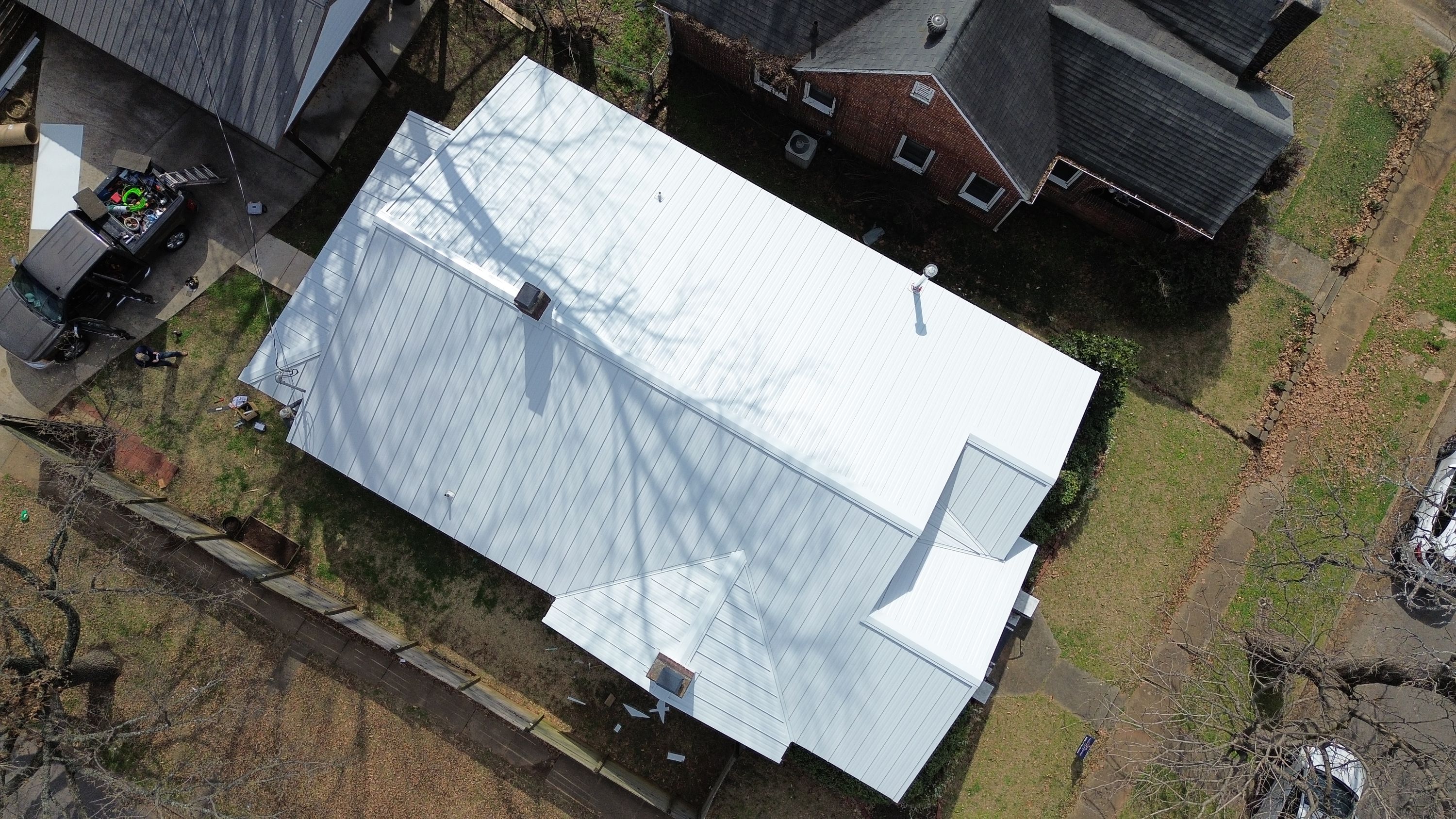 Top-down view of a new white standing seam metal roof installed on a Birmingham home in Glen Iris.