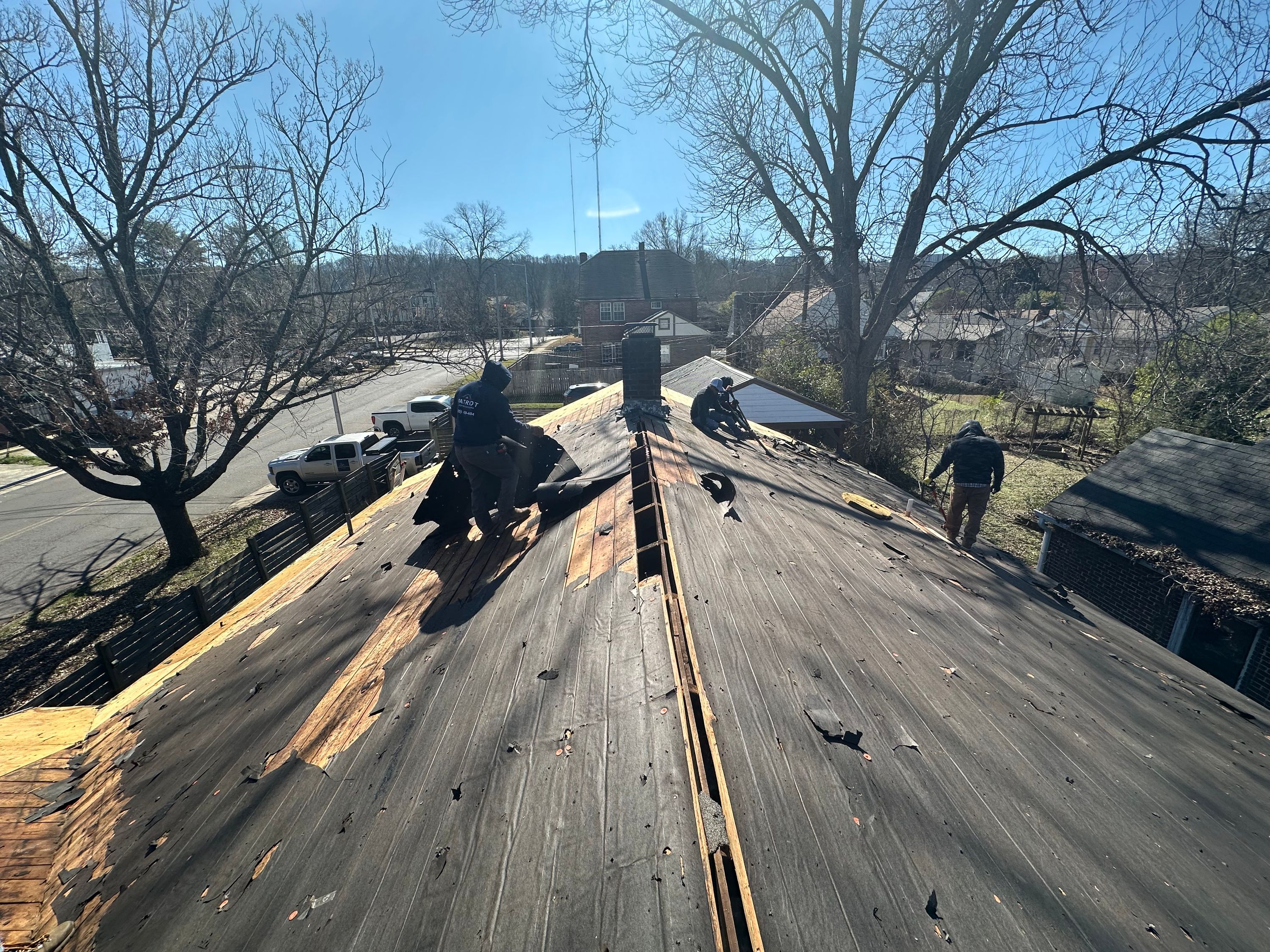 Roofing crew stripping old materials during a residential roof replacement in Glen Iris, Birmingham.
