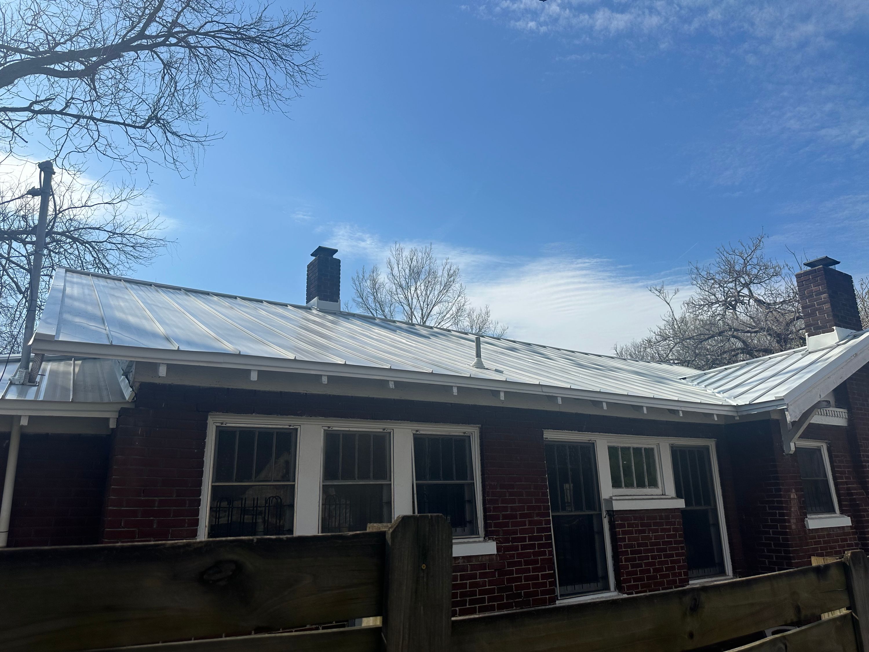 Newly installed silver metal roof on a classic brick home in Glen Iris, Birmingham.