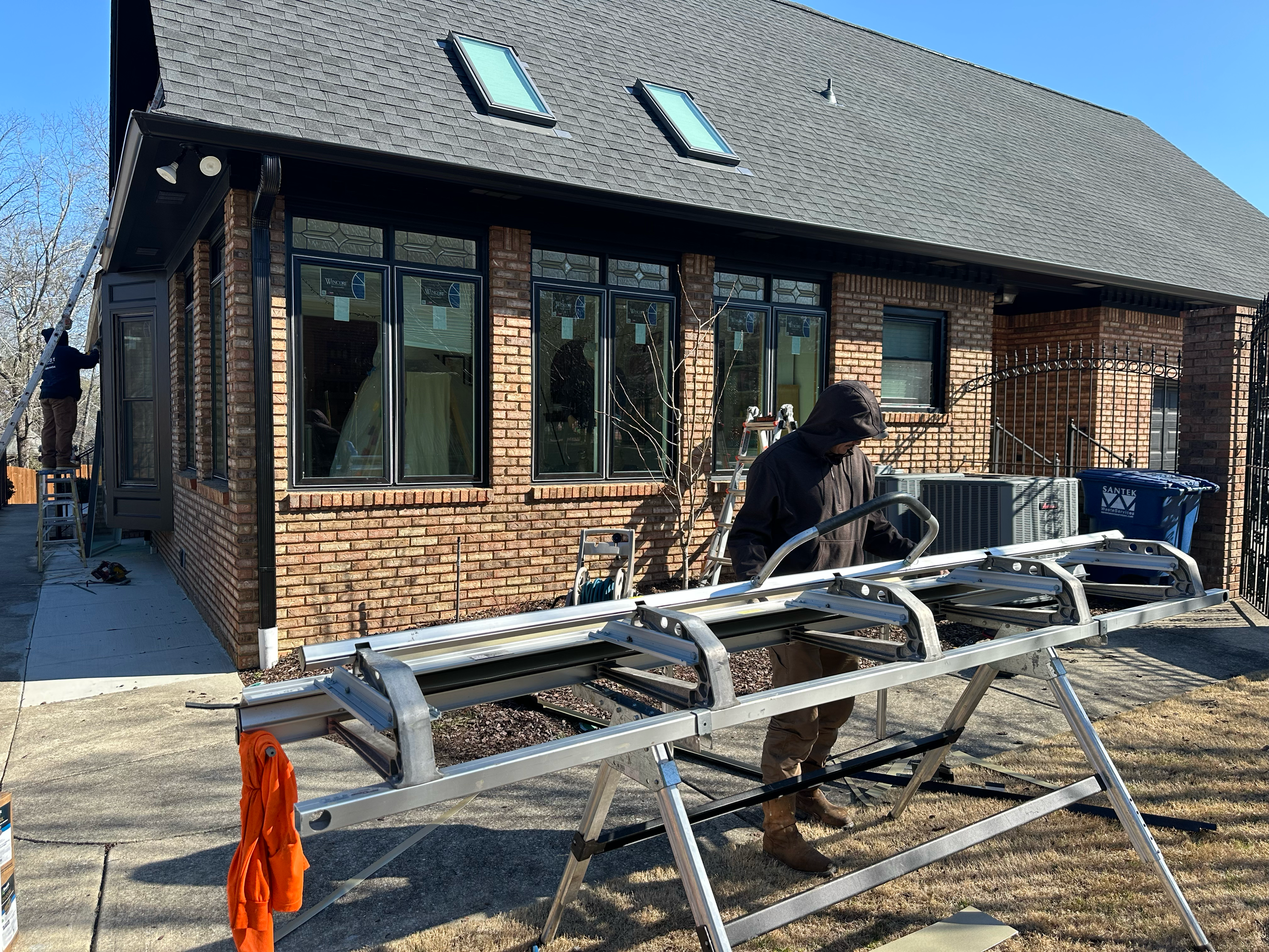 Patriot Roofing & Builders contractor using a metal brake for custom window capping on a Hoover, AL home.