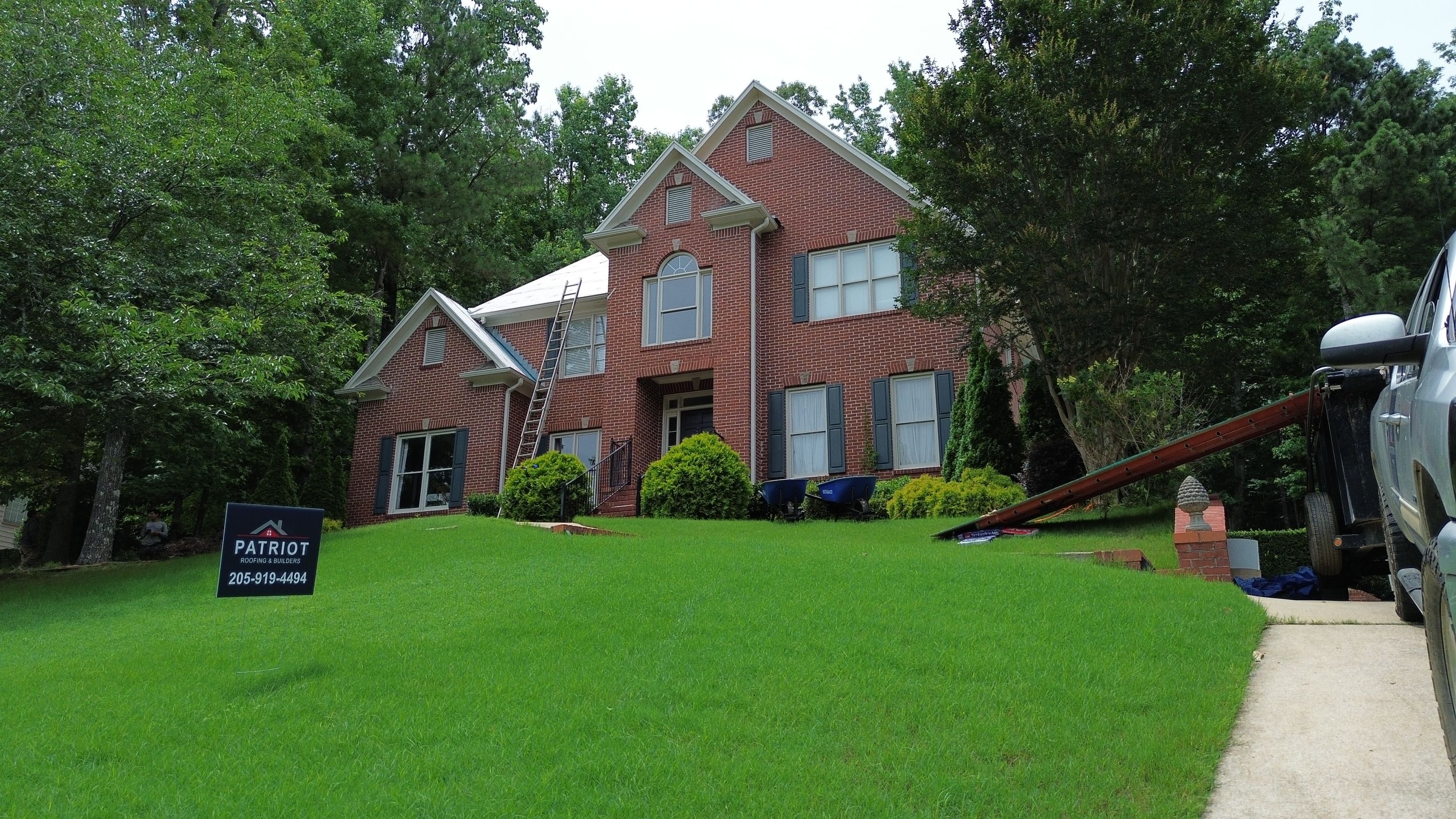 Roof replacement preparation on a brick home in Hoover with underlayment installed.