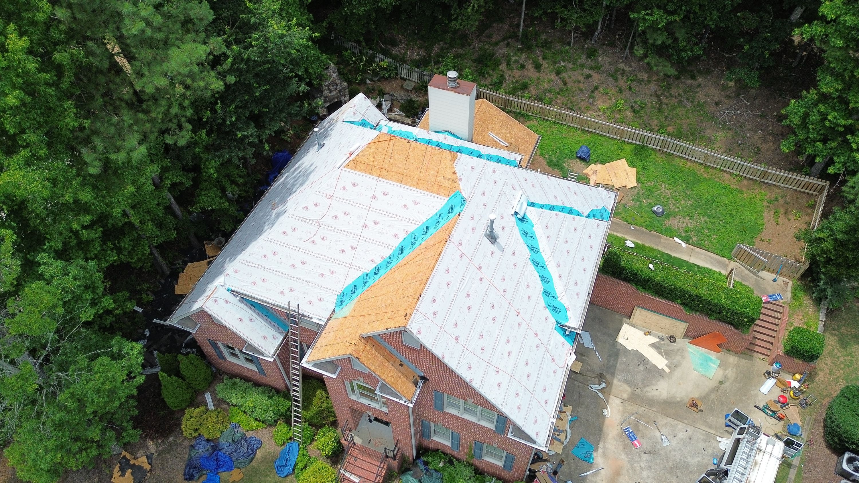 Synthetic underlayment and decking visible during a home roof replacement in Hoover.