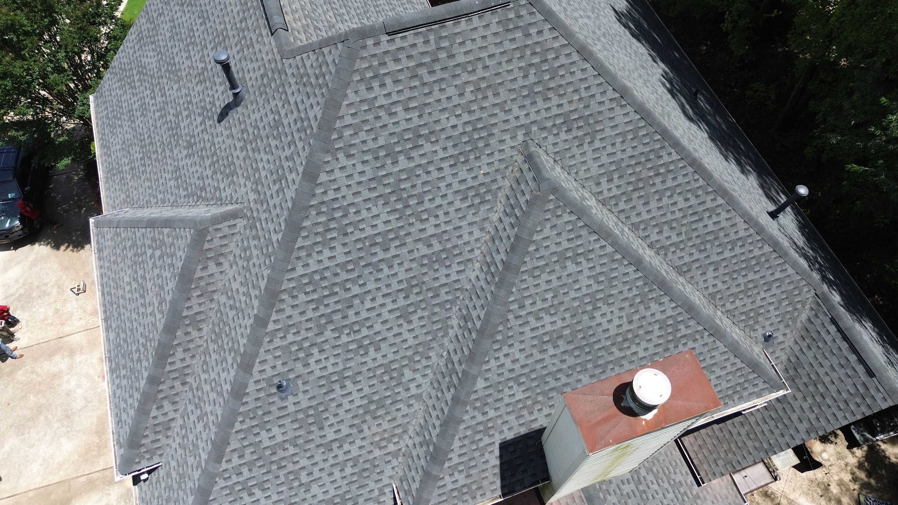 A newly completed roof replacement featuring gray asphalt shingles on a home in Hoover.
