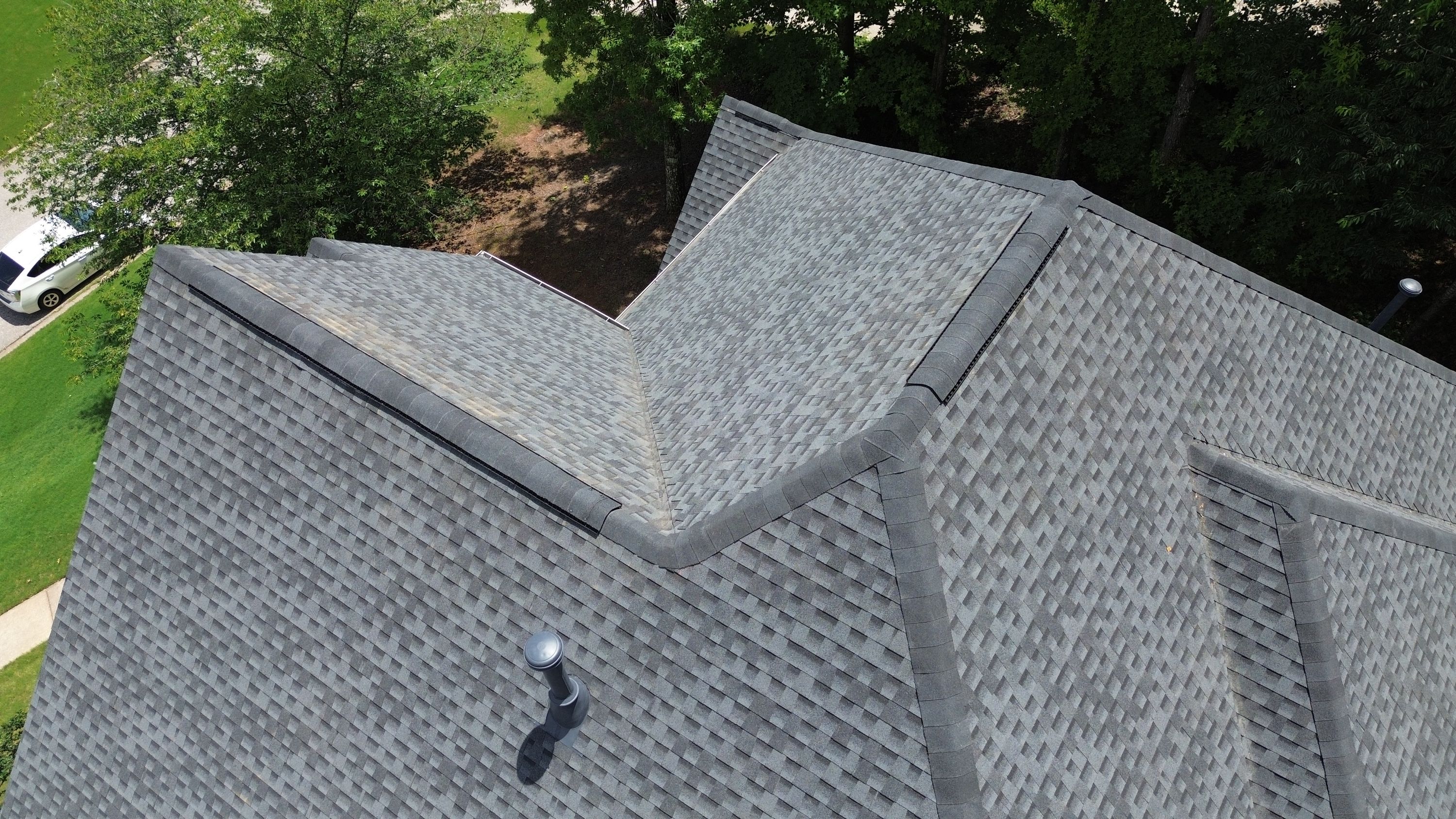 A newly completed gray architectural shingle roof replacement on a home in Hoover.