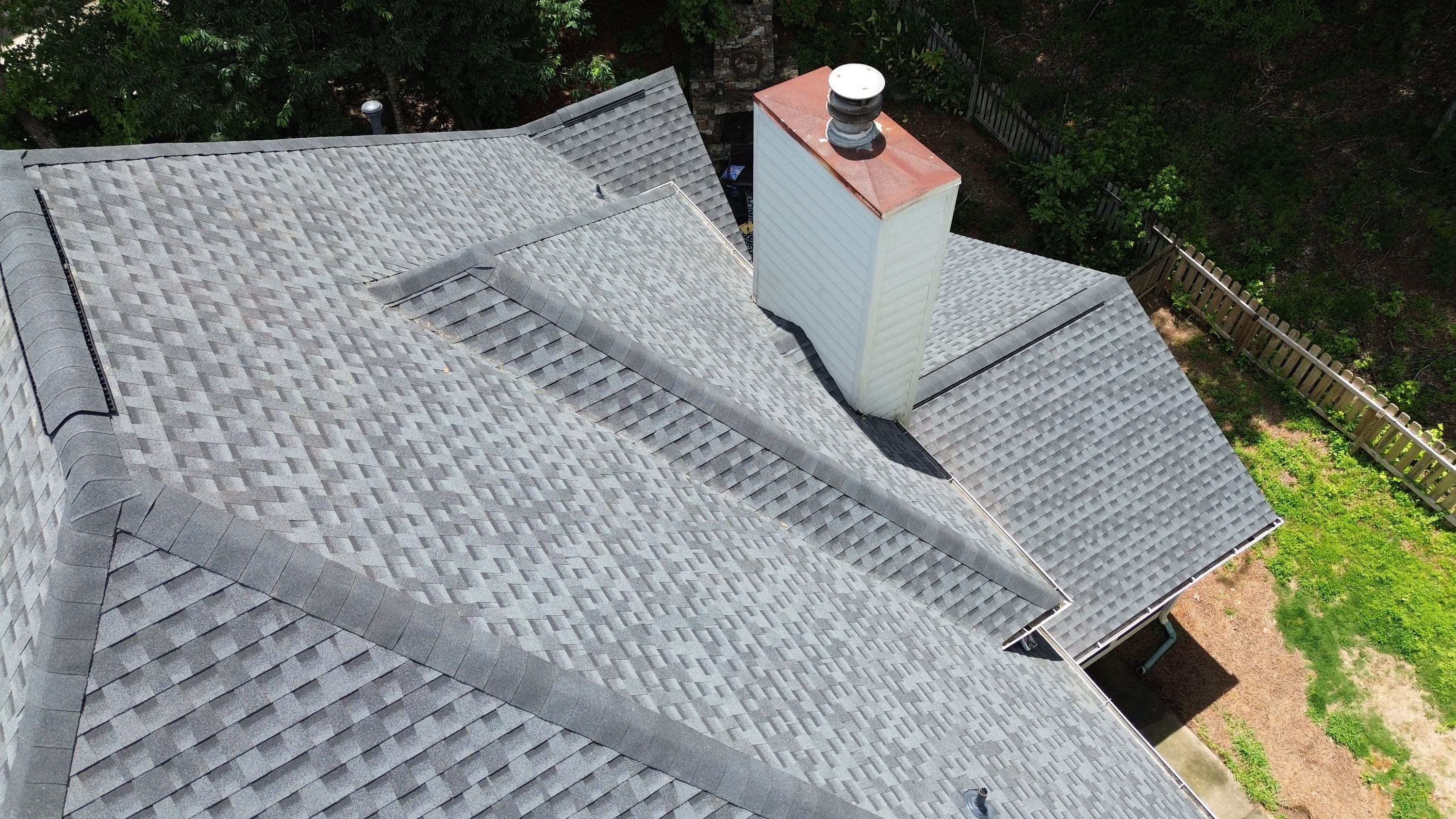 Newly installed gray architectural shingles on a completed roof replacement in Hoover.