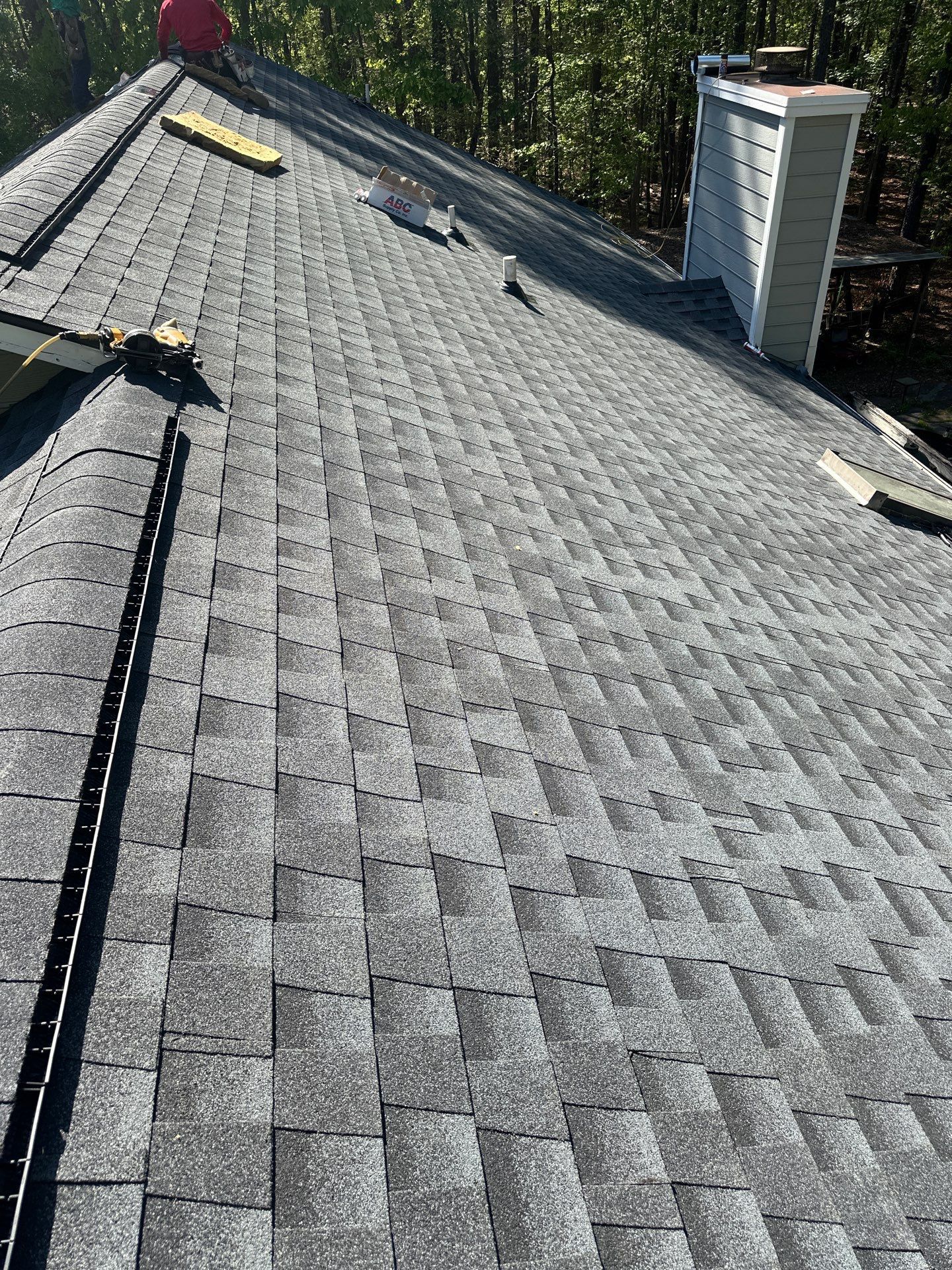 A new gray asphalt shingle roof installation in progress on a home in Chelsea.