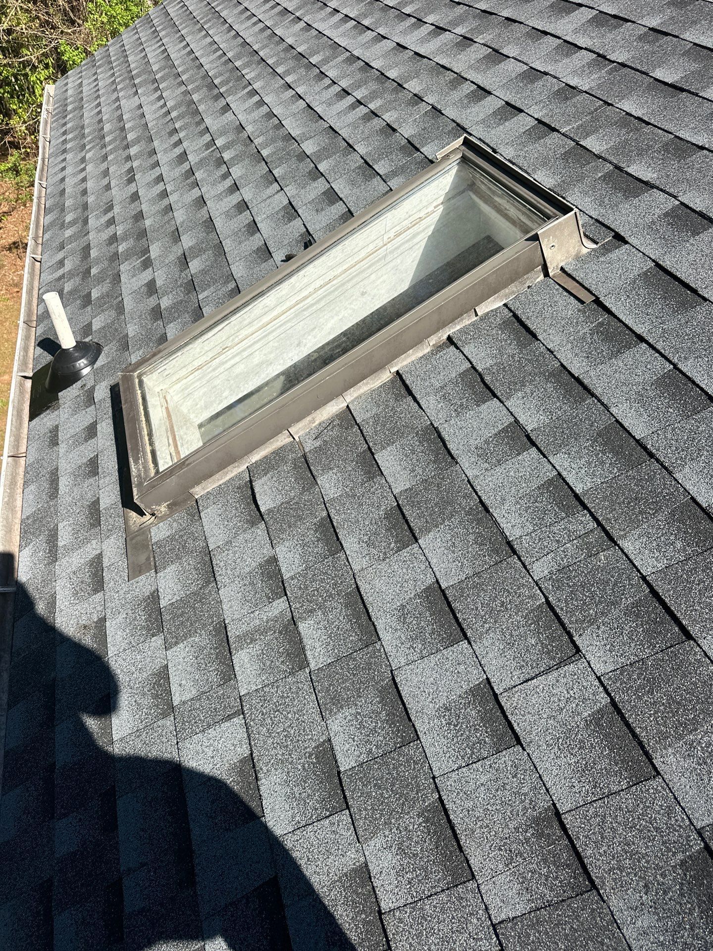 A new asphalt shingle roof replacement with a skylight installation on a home in Chelsea.