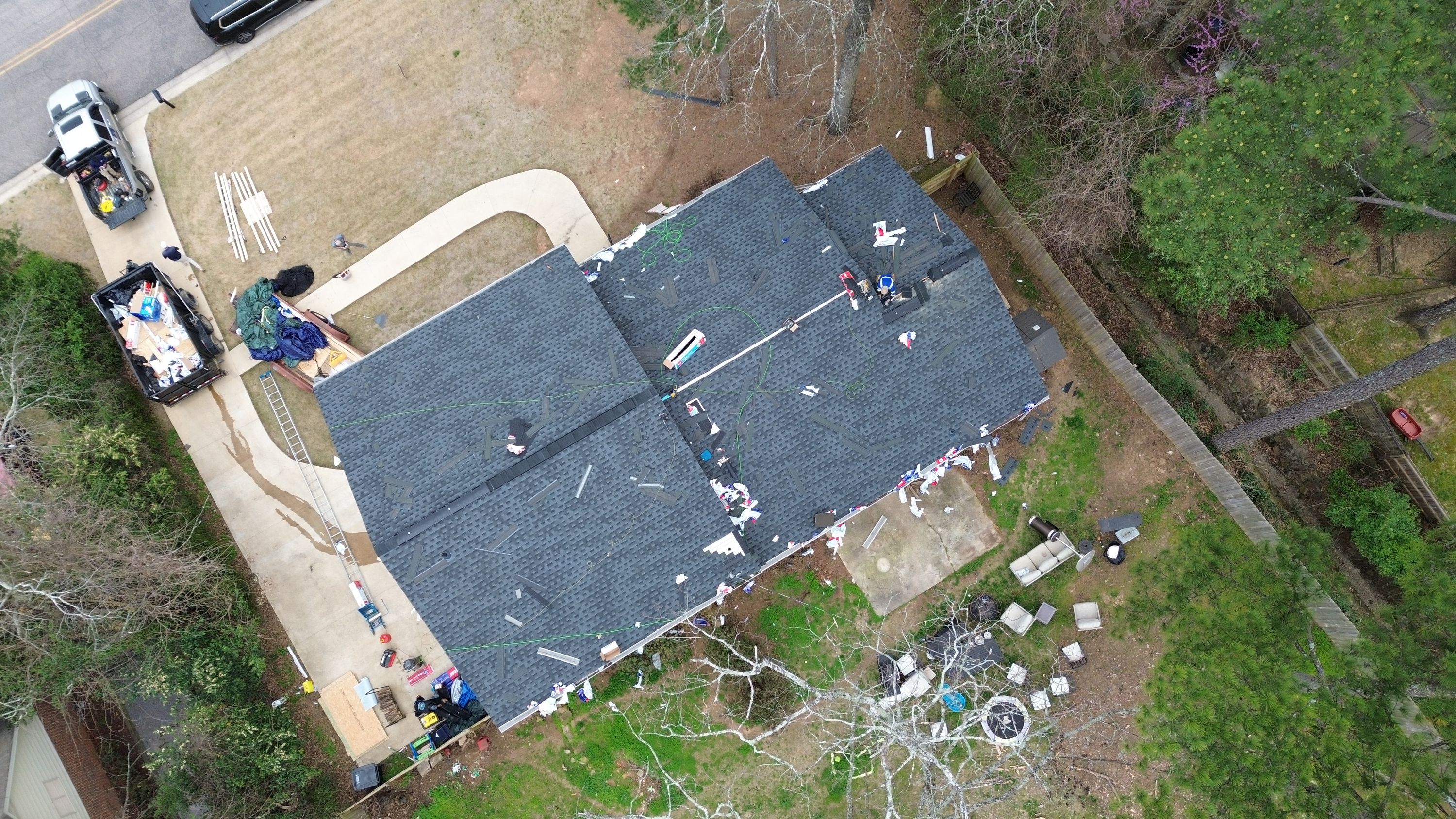 Aerial view of a roof replacement in progress for a Brookwood Forest home in Mountain Brook.