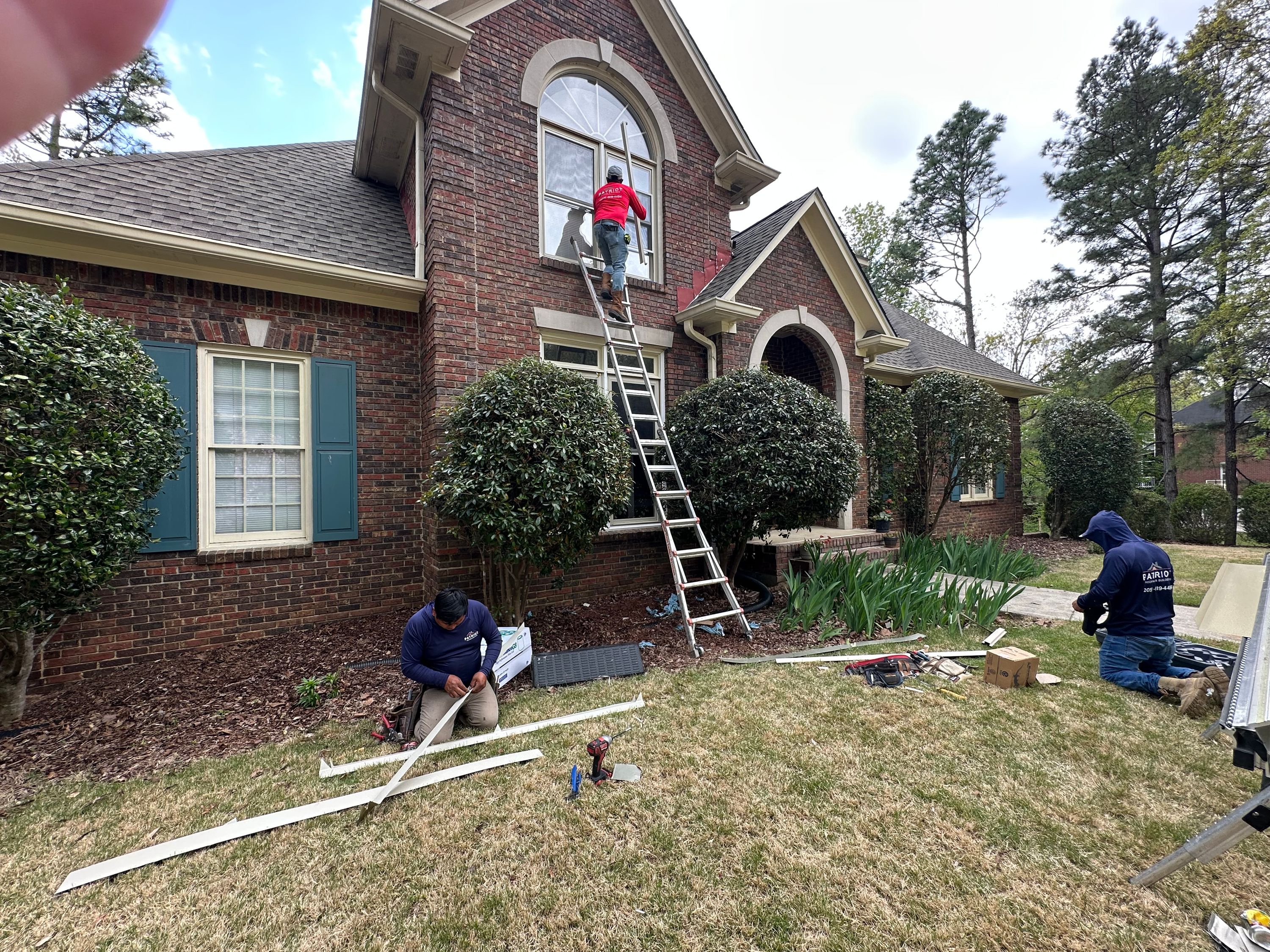 Patriot Roofing and Builders prepares trim coil for a window replacement at a Meadowbrook home.