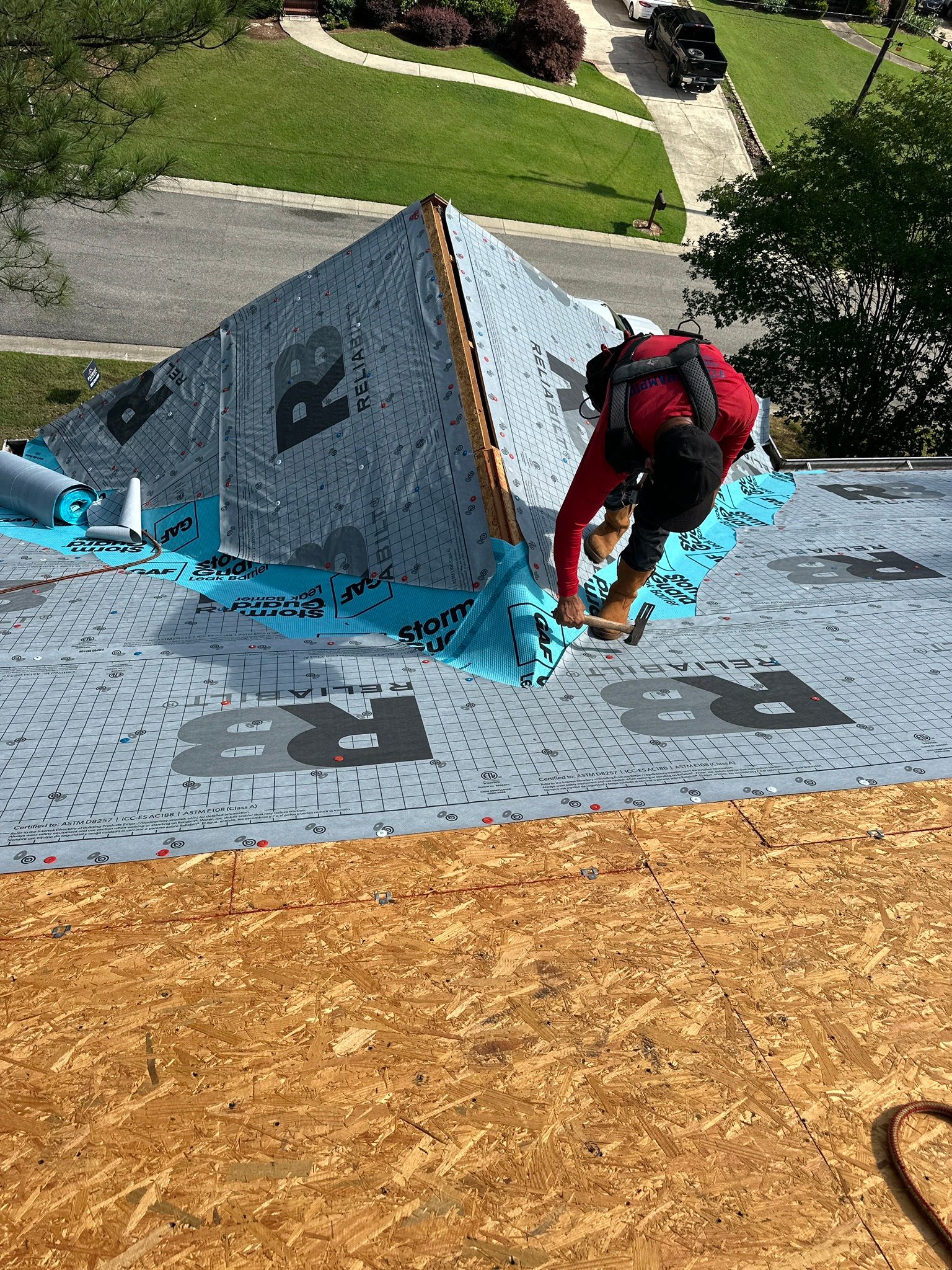 Installing protective underlayment and leak barrier during a residential roof replacement in Helena.