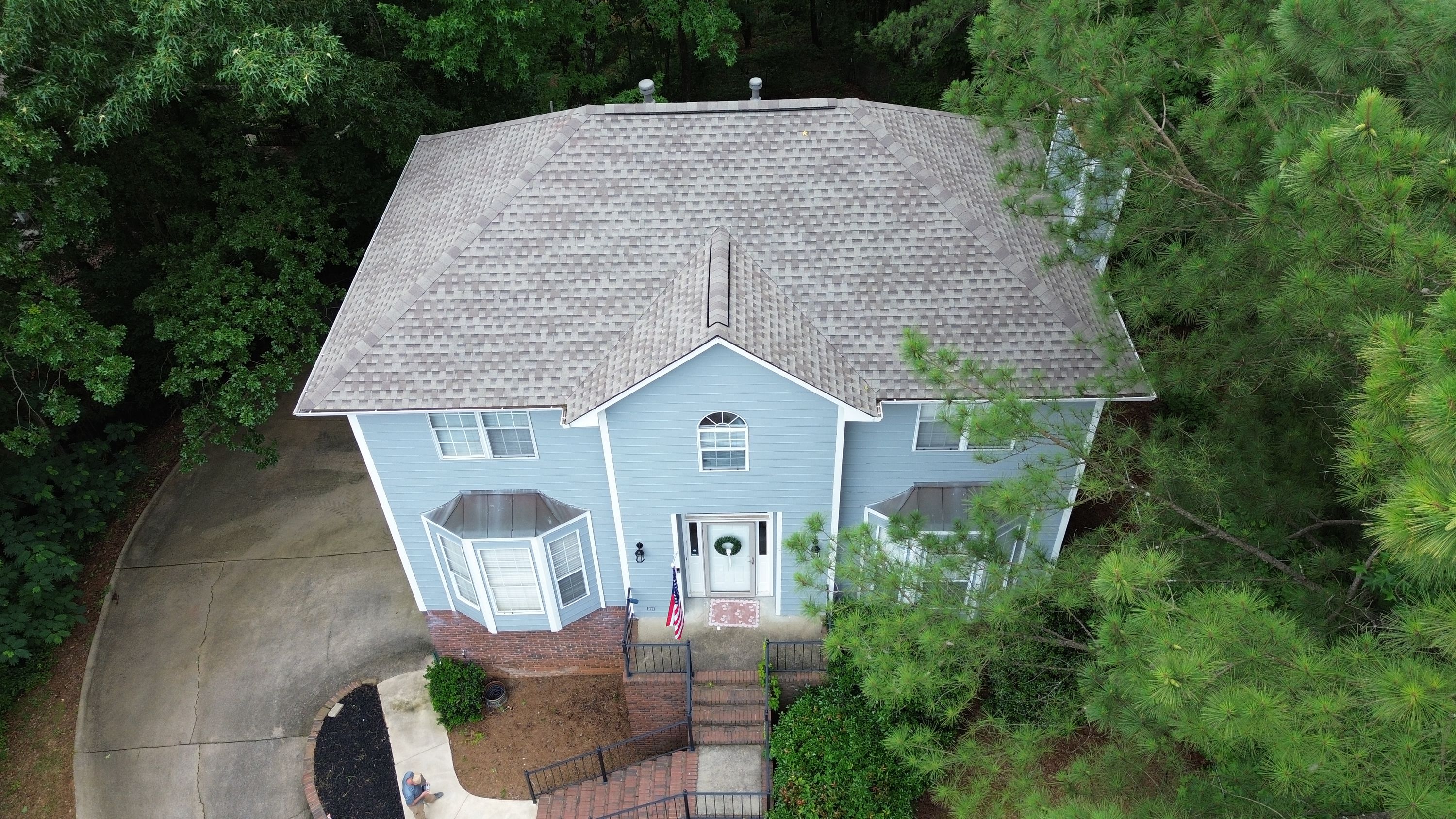 Aerial view of a completed roof replacement with new asphalt shingles on a Helena home.