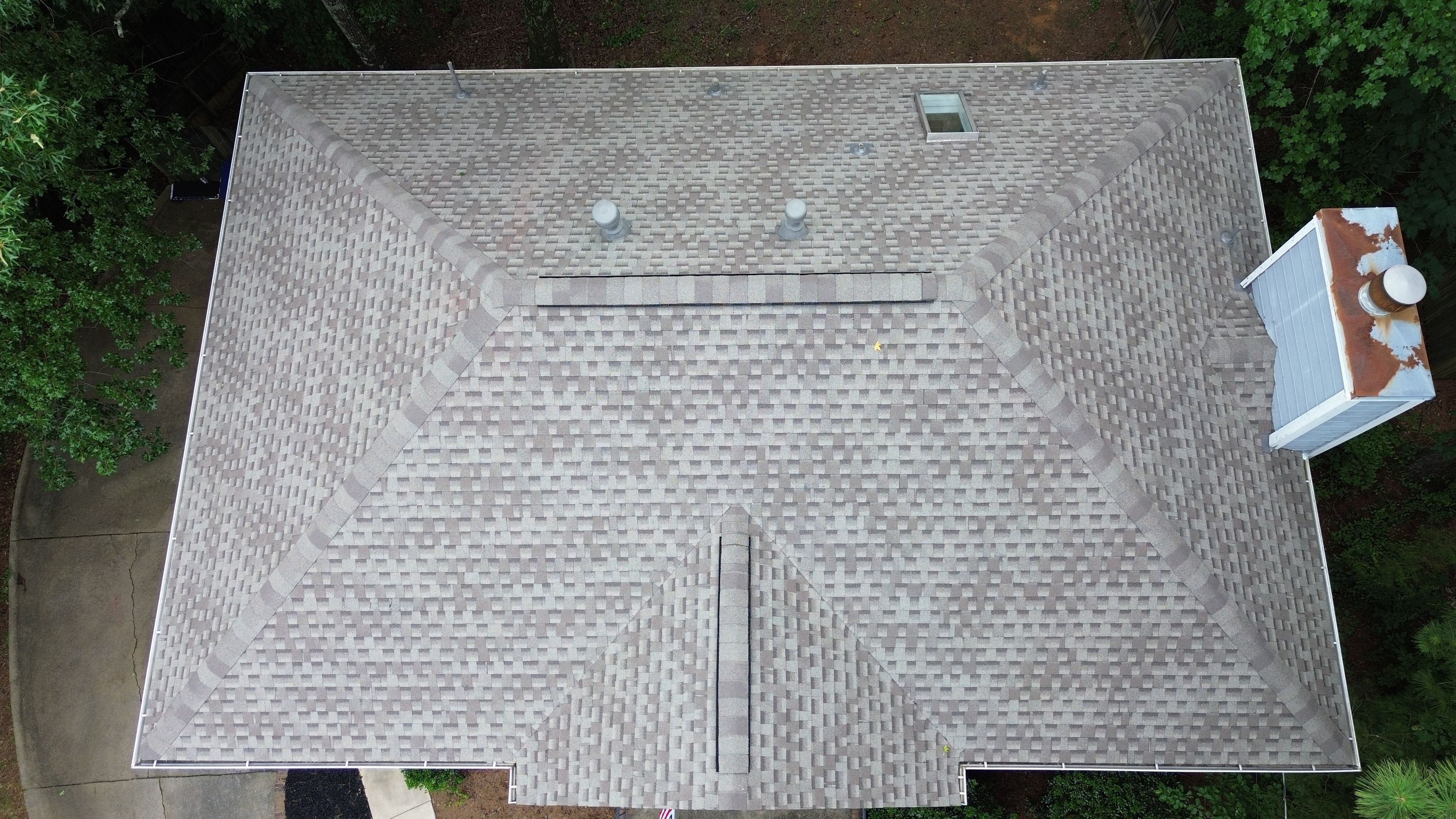 Aerial view of a completed roof replacement with grey asphalt shingles in Fieldstone Park, Helena.