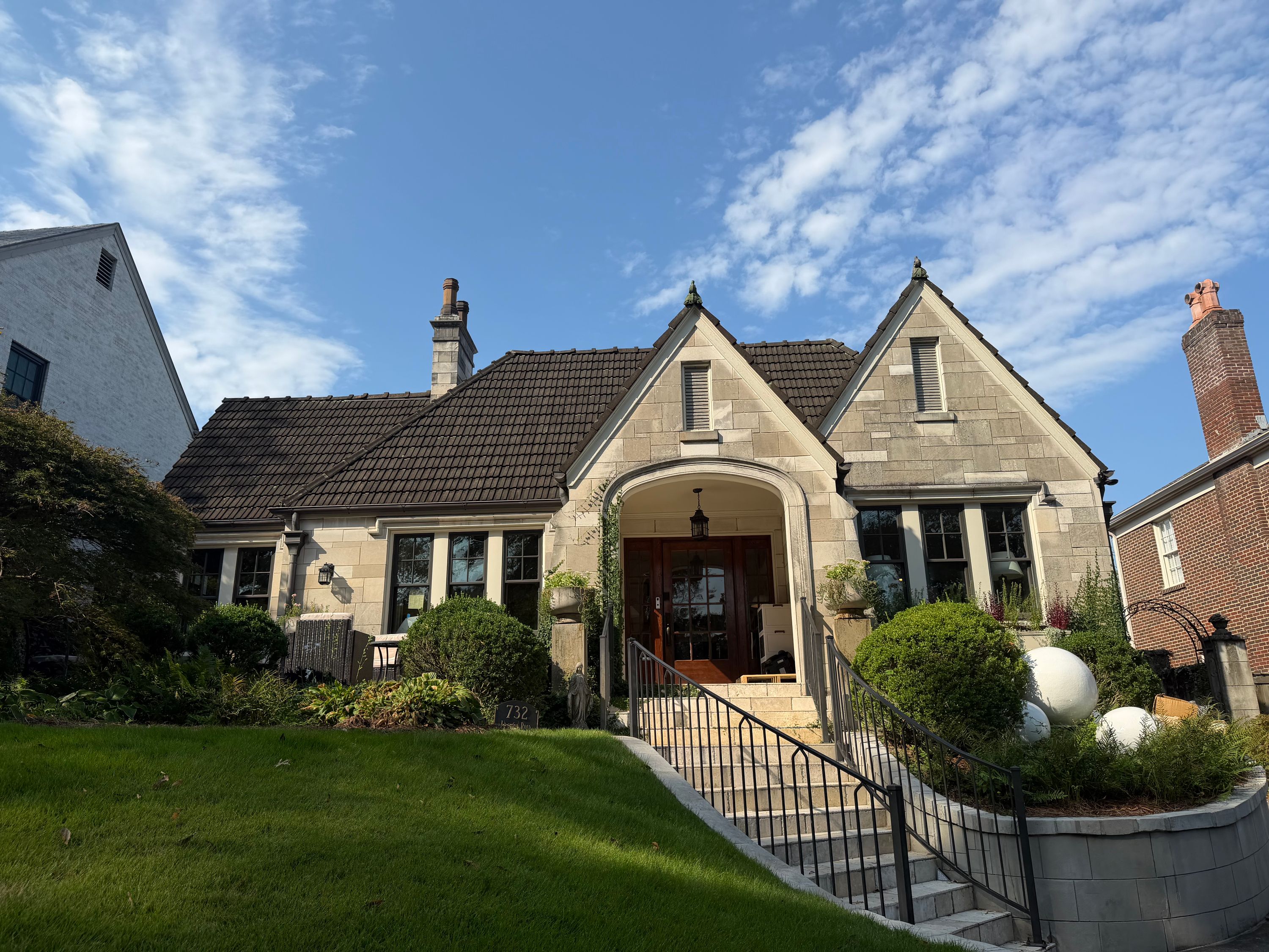 Concrete tile roof and stone gables on a home undergoing roof repair in Birmingham.