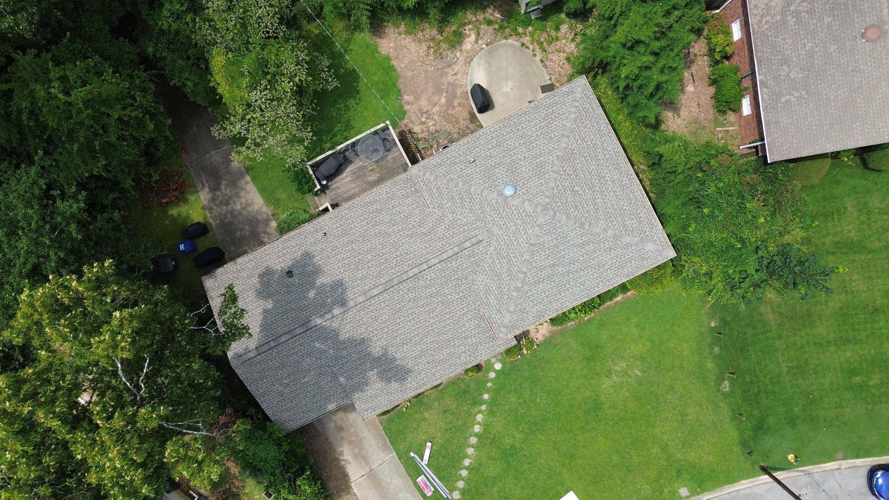 An overhead aerial view displays the geometric pattern of newly replaced shingles on a multi-plane roof in Birmingham.