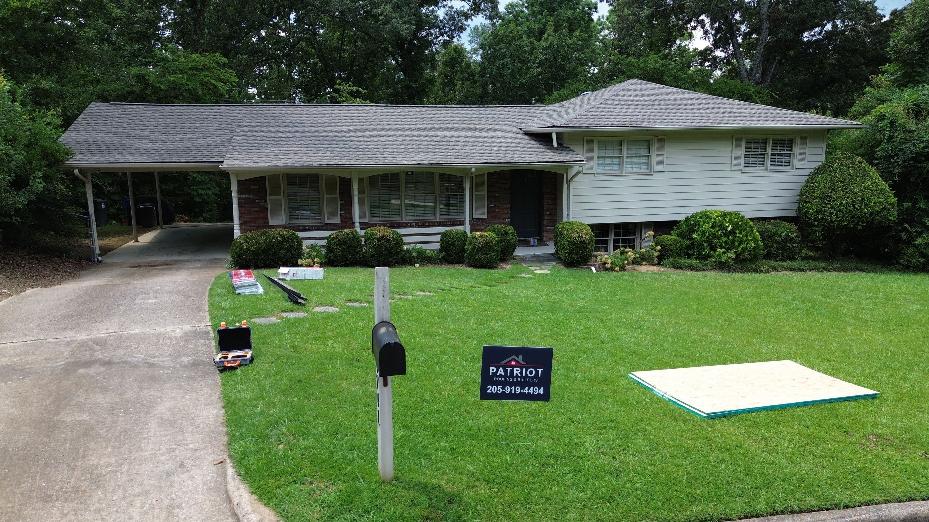 Post-installation view highlights the clean shingle lines above the front porch and entryway.