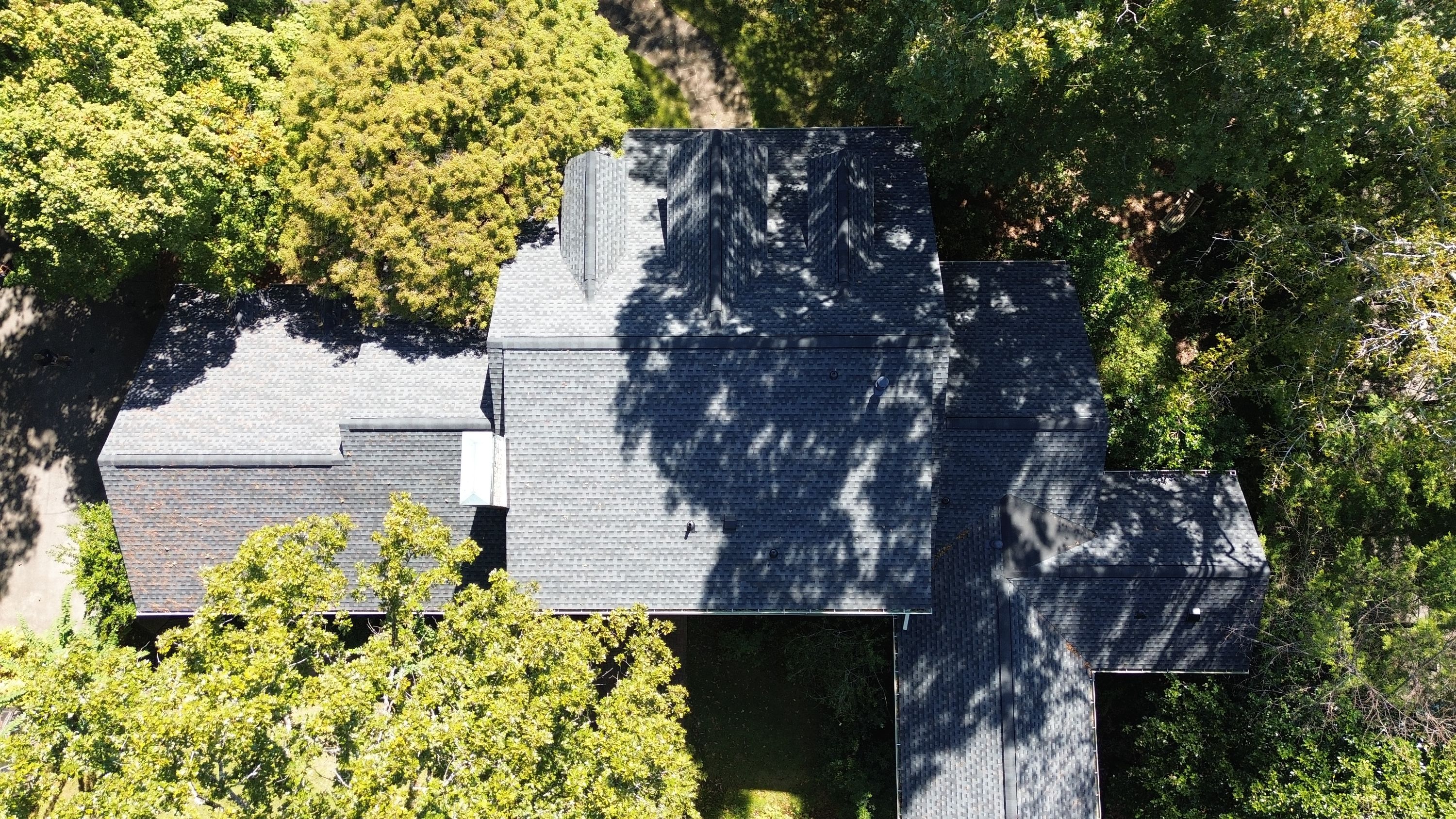 Overhead view of front dormers and main slopes with new shingle roofing in Cherokee Bend, Mountain Brook.