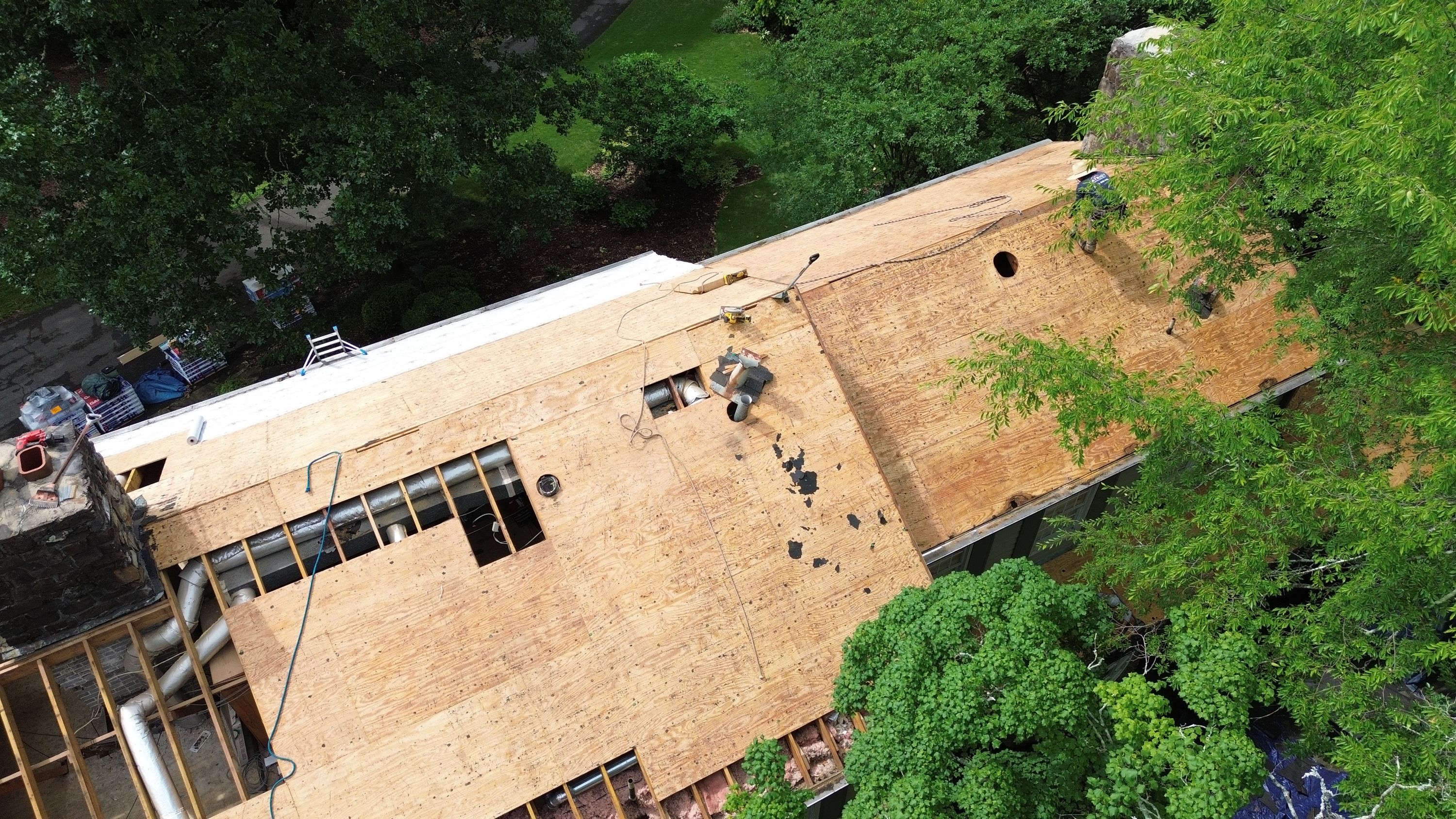 Plywood decking exposed during a roof replacement on Old Leeds Road in Mountain Brook.