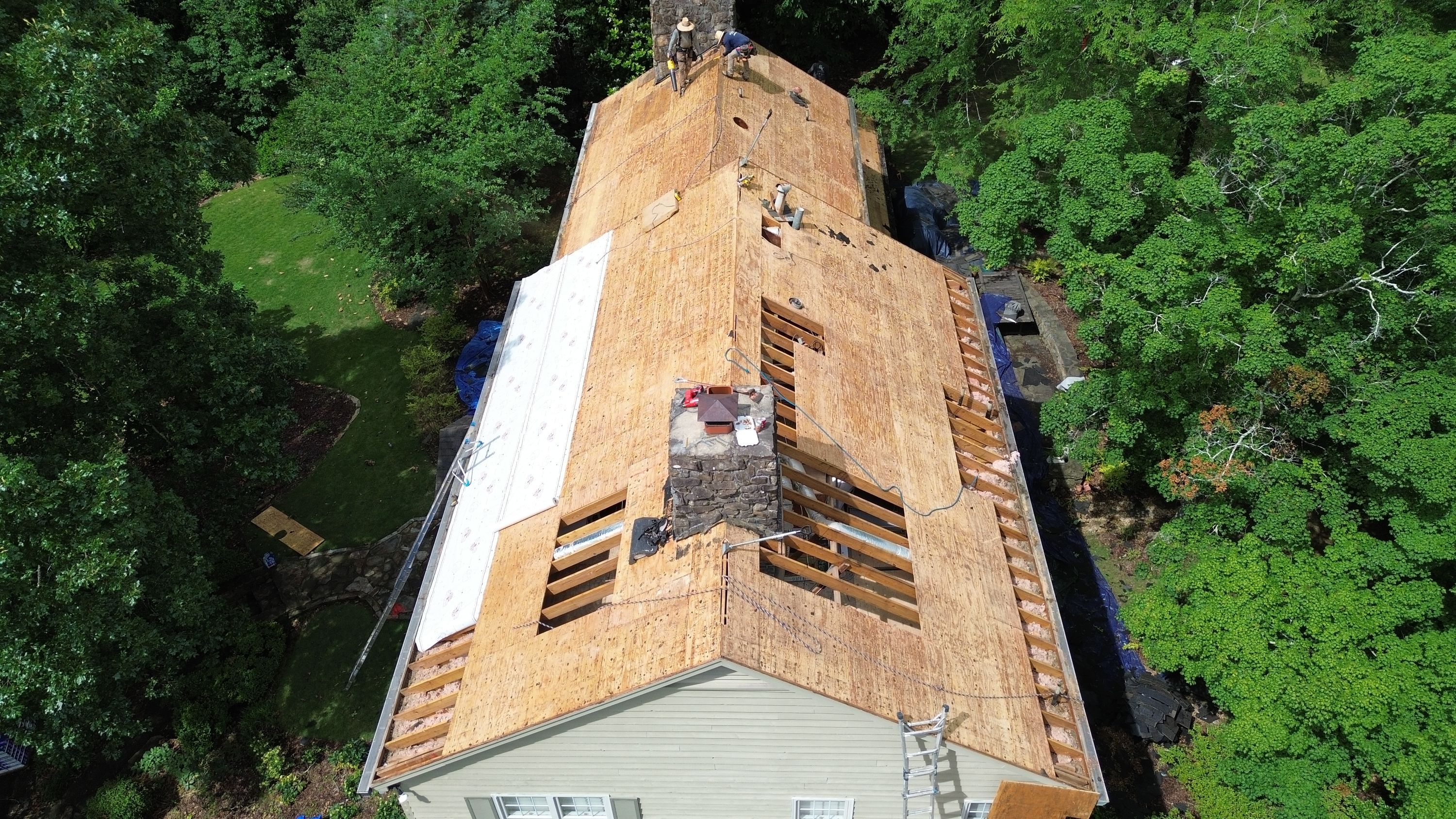 Plywood decking and underlayment during a residential roof replacement in Mountain Brook.