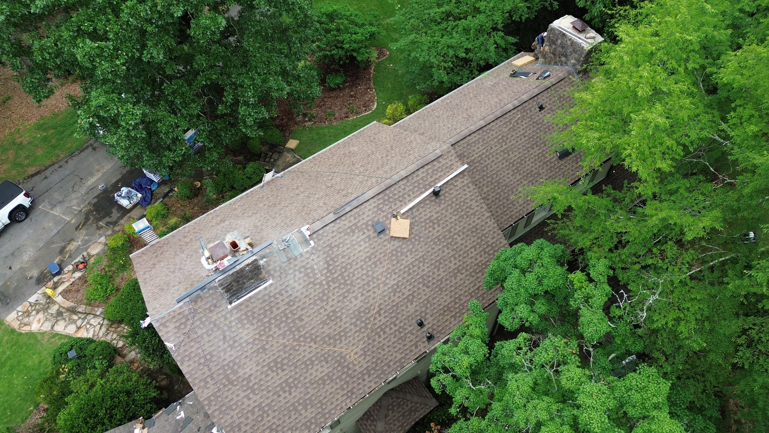 Roof replacement project showing new asphalt shingles on a home near Old Leeds Road in Mountain Brook.