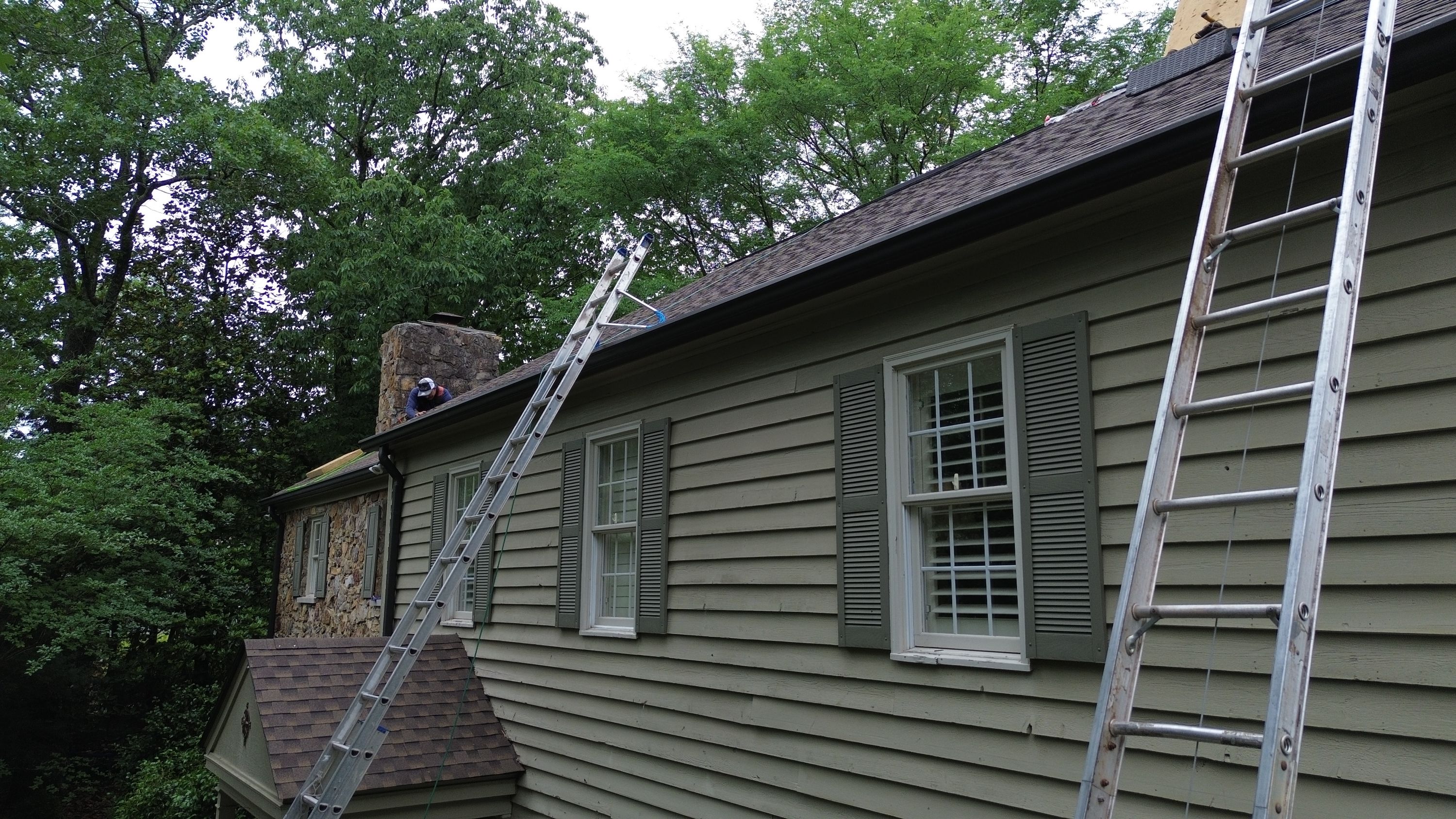 Ladders lean against a residential home during a roof replacement project in Mountain Brook.