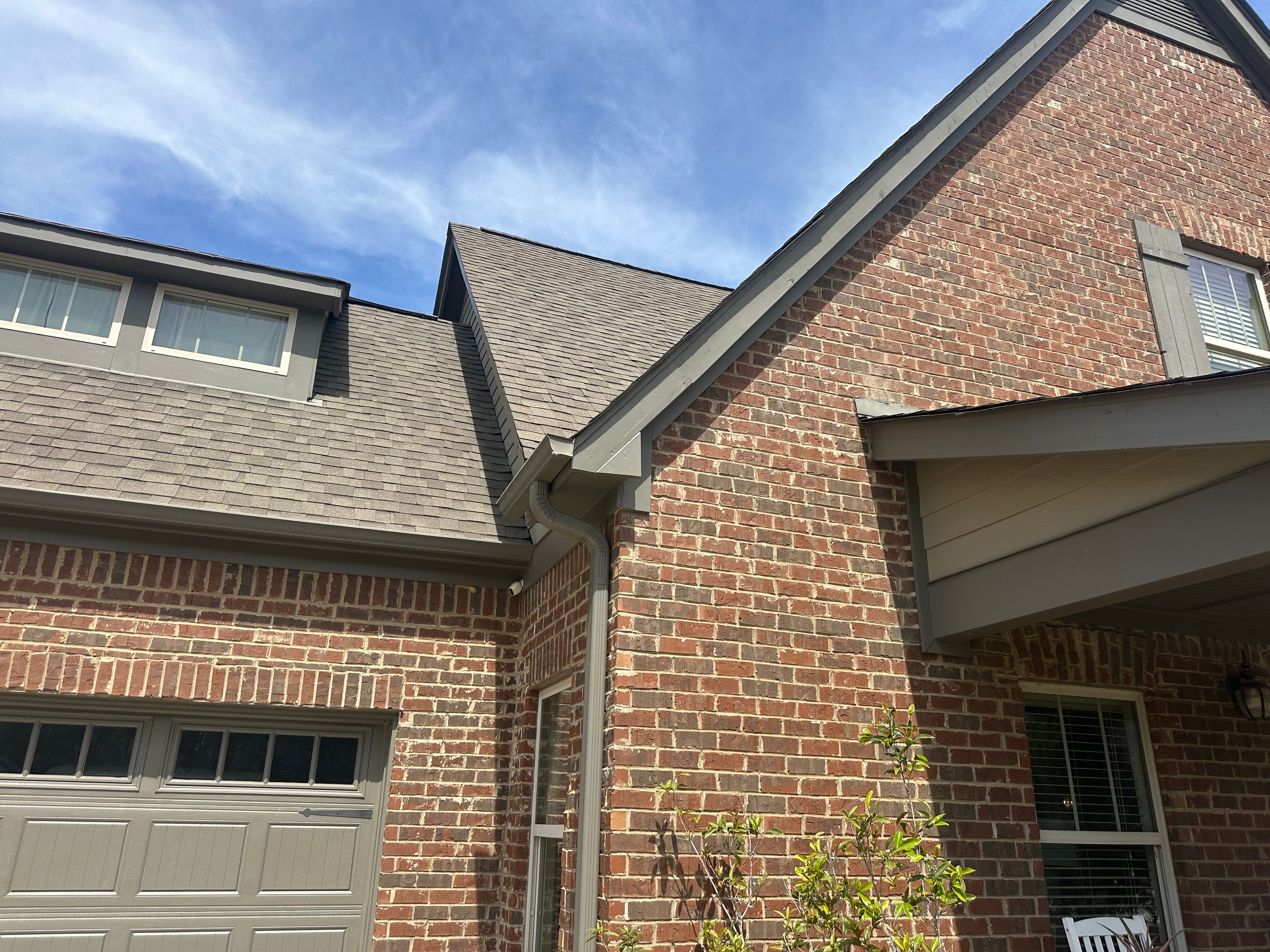 Completed roof repair and window replacement on a brick home in Chelsea Park.