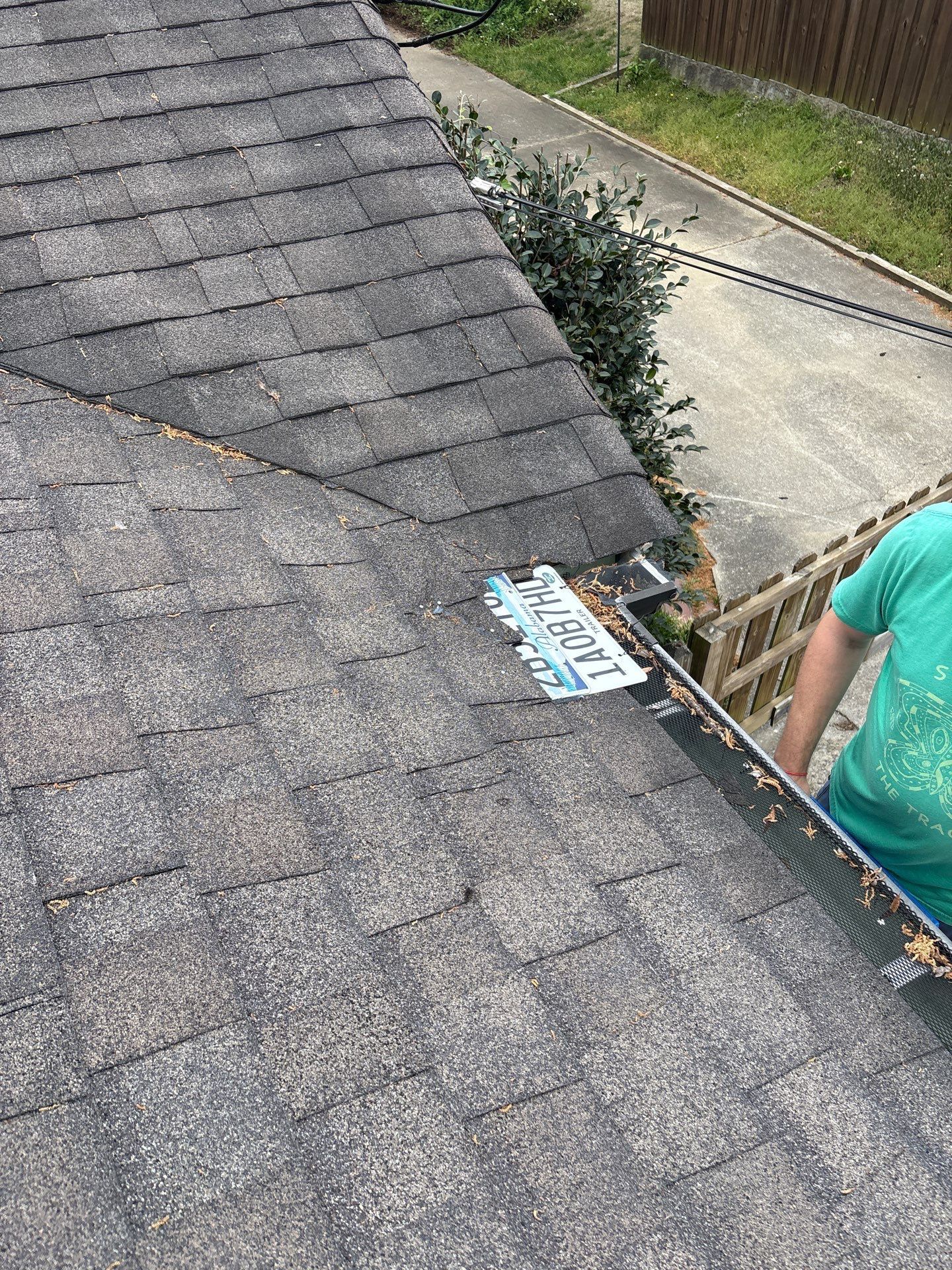 A license plate serves as makeshift flashing near the gutter run on this Old Irondale home before a gutter repair.