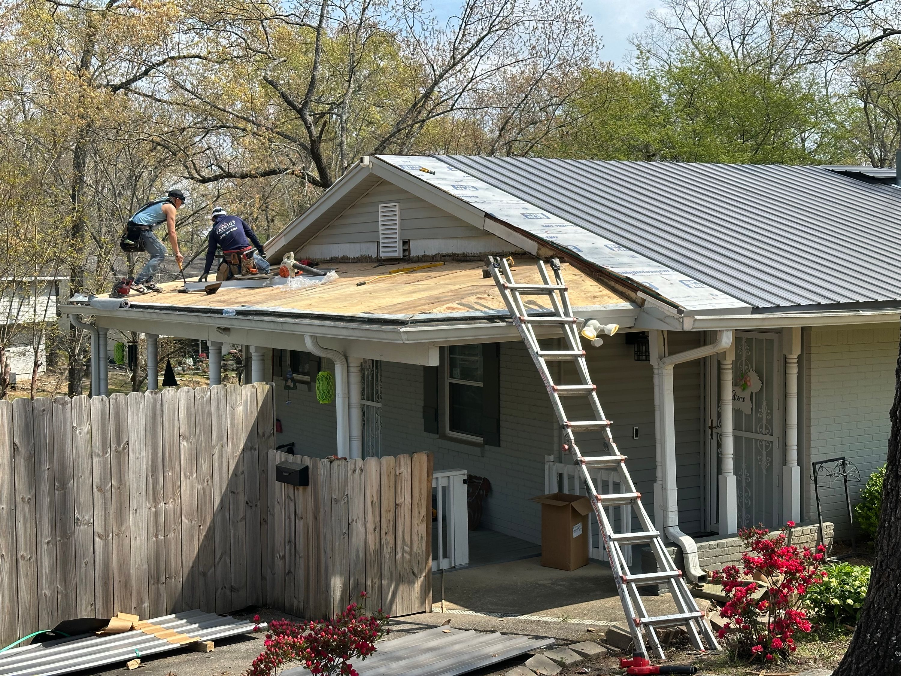 Roofing team installing a new standing seam metal roof on a home in Vestavia Hills.