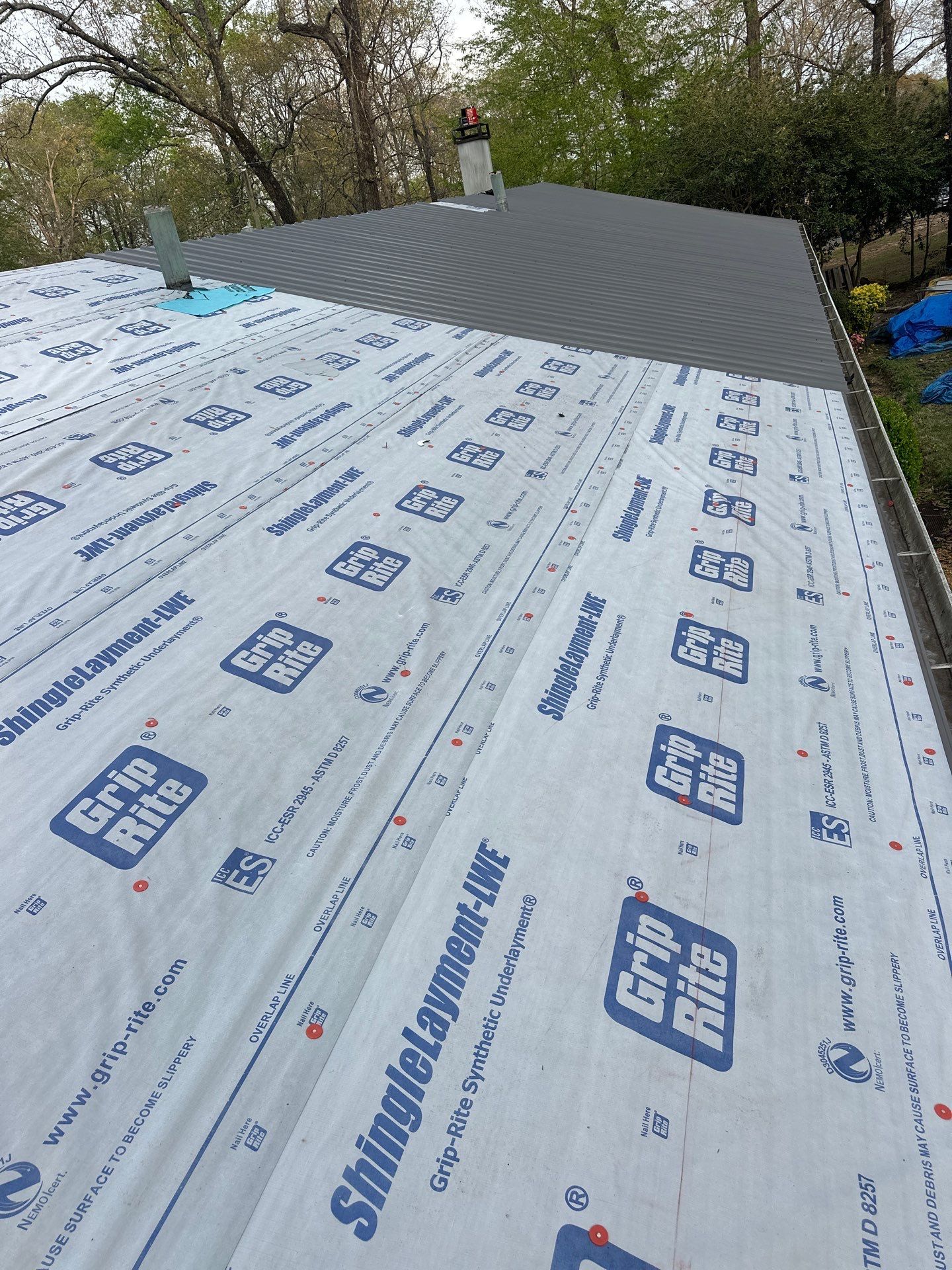 Gray standing seam metal roofing and synthetic underlayment installation in Cahaba Heights.