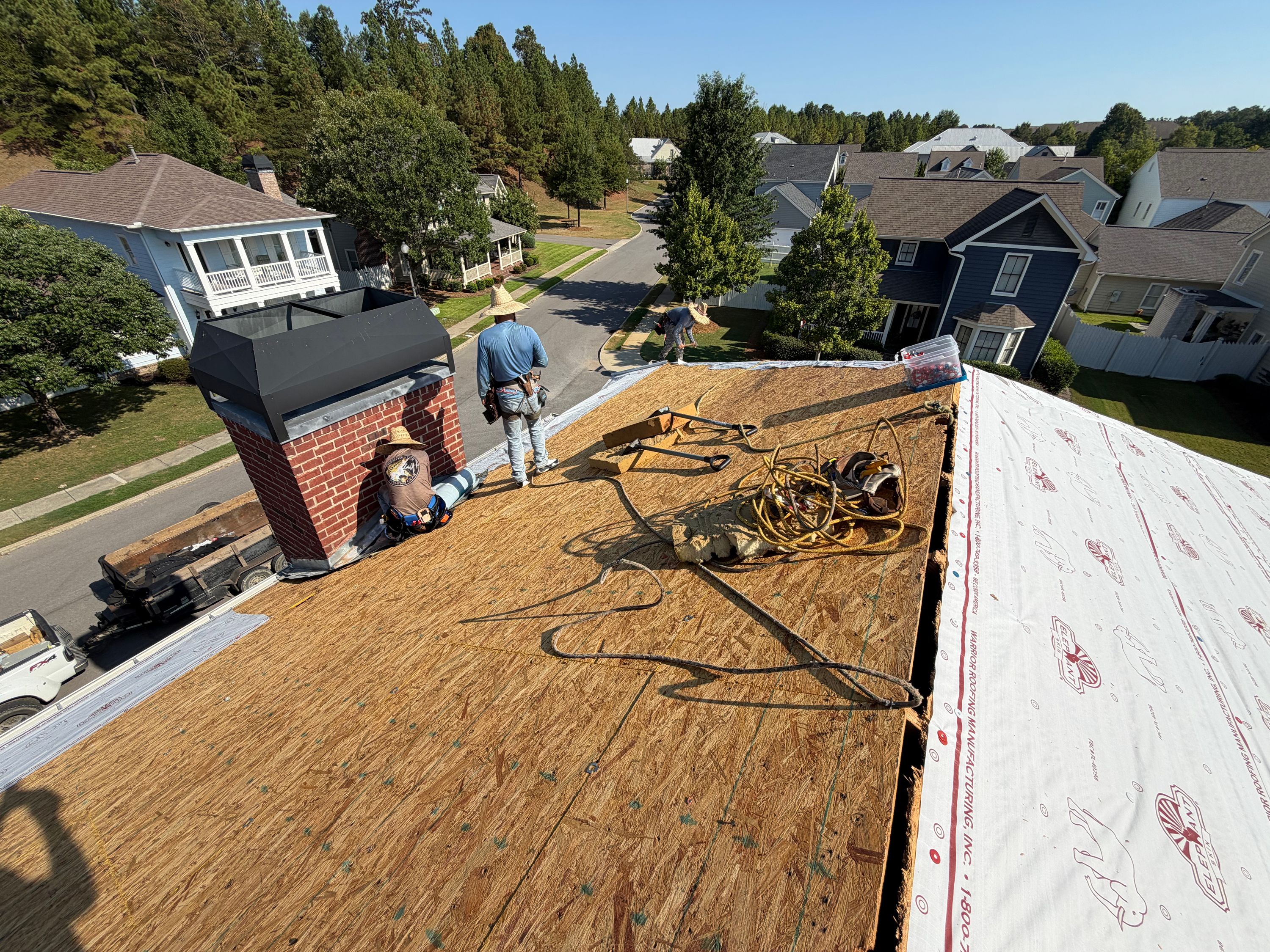 Stripping tools and safety ropes rest on newly installed OSB roof decking in the Beaumont neighborhood.