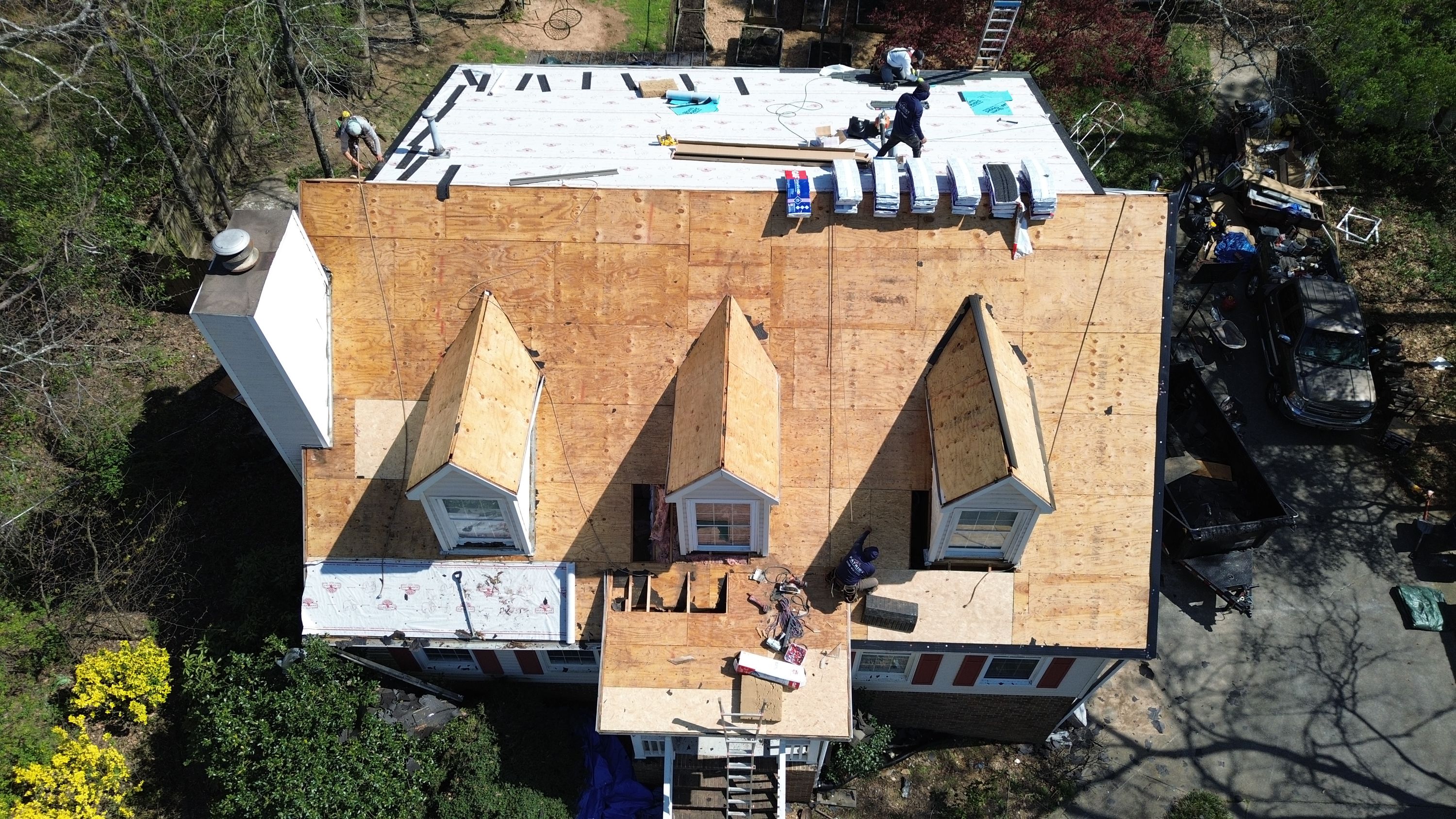 Aerial view of a home roof replacement in Bluff Park with new plywood decking and dormers.