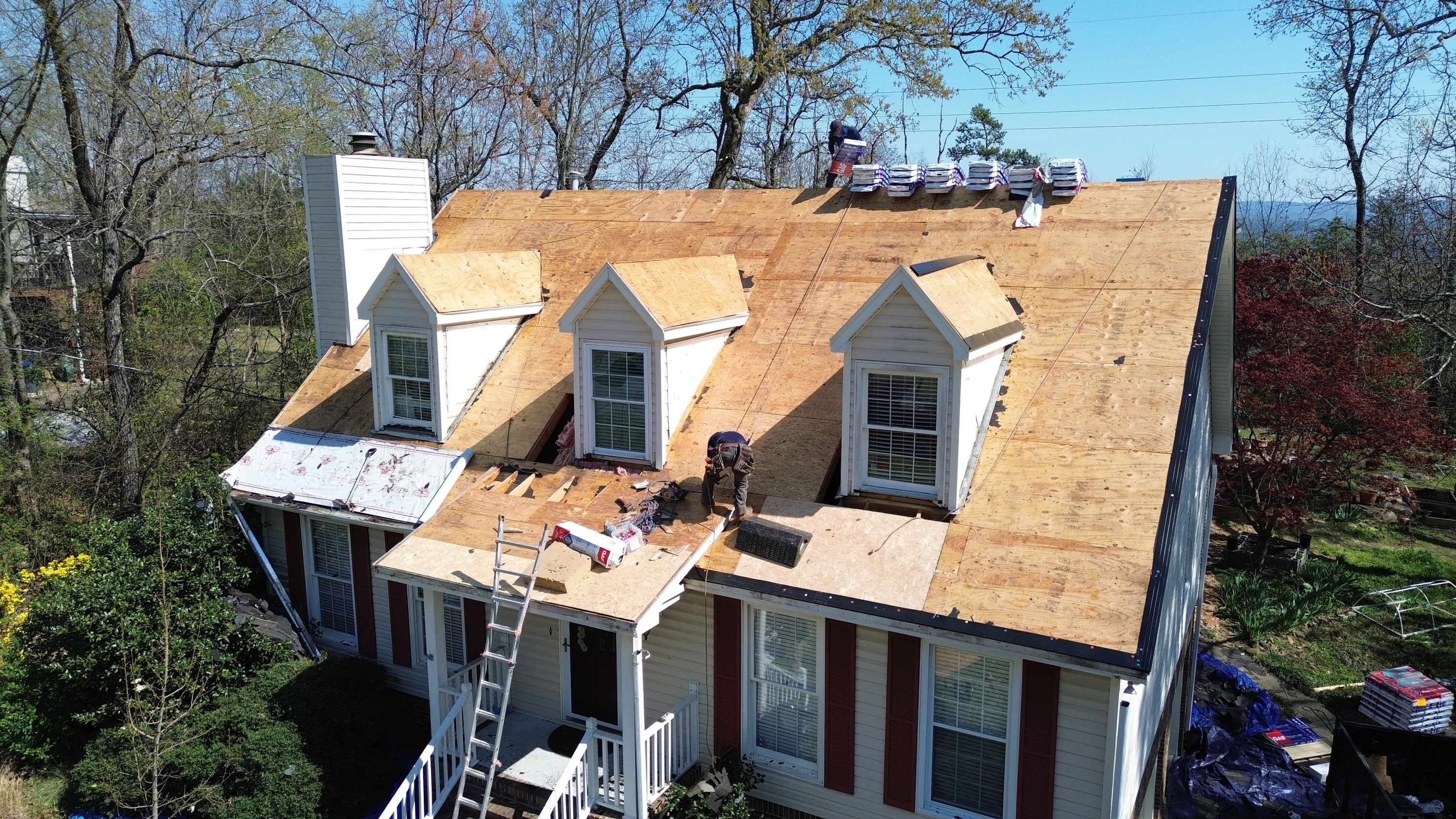 Roof replacement project in progress on a residential home with three dormers in Bluff Park, Hoover.