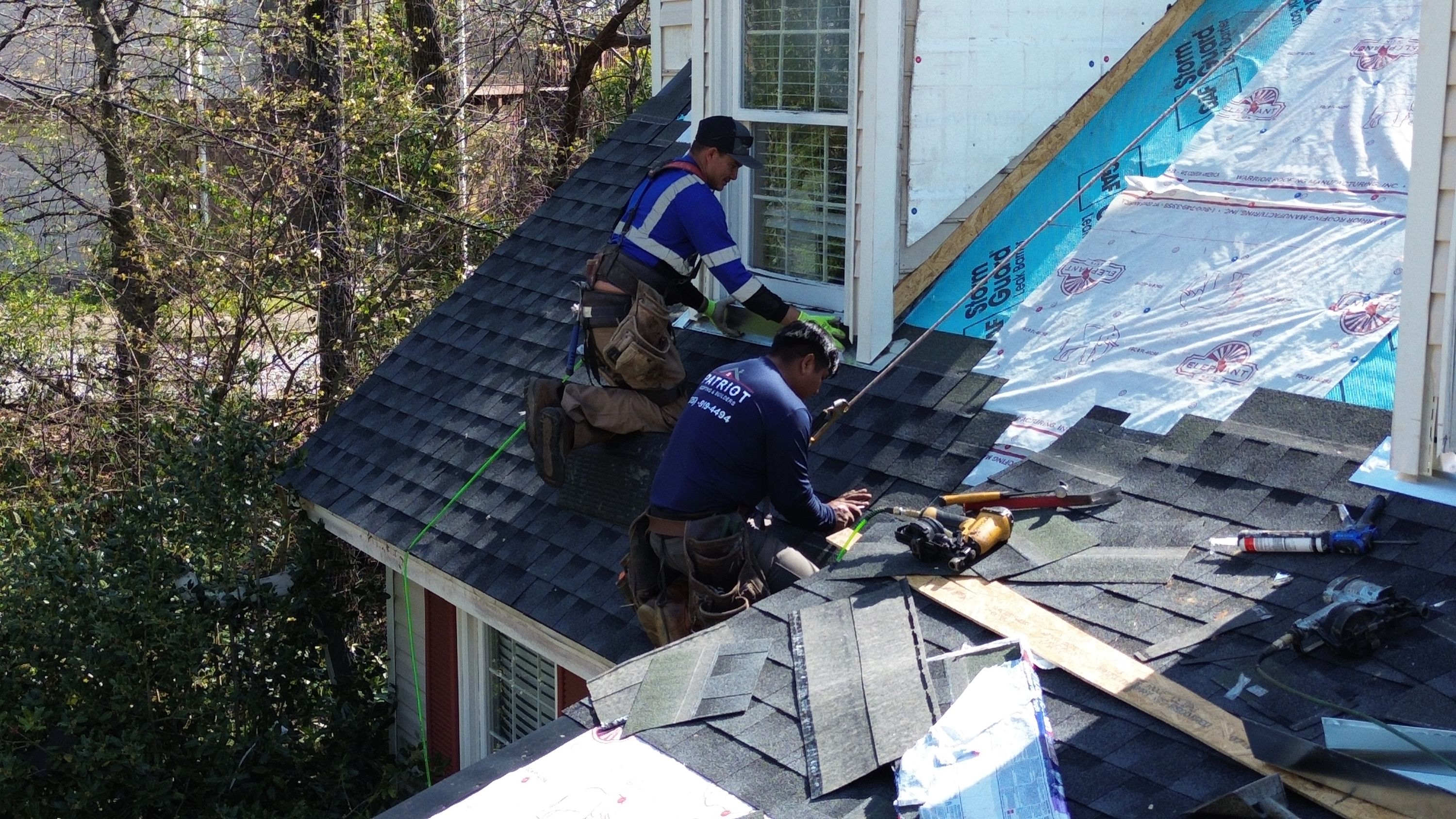 Patriot Roofing and Builders installing architectural shingles over underlayment on a Bluff Park roof.