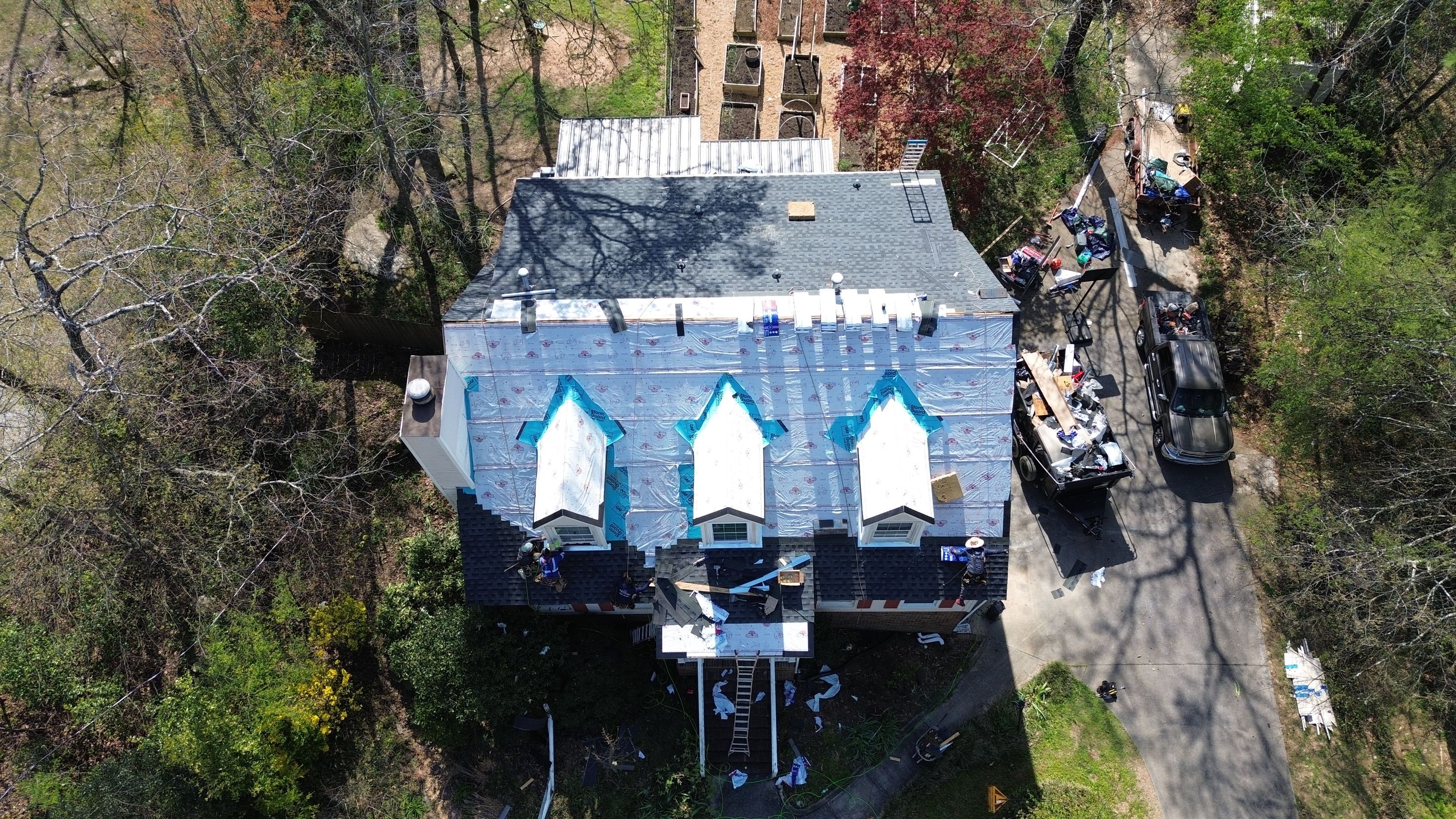 Patriot Roofing and Builders installing synthetic underlayment and new shingles on a Bluff Park roof replacement.