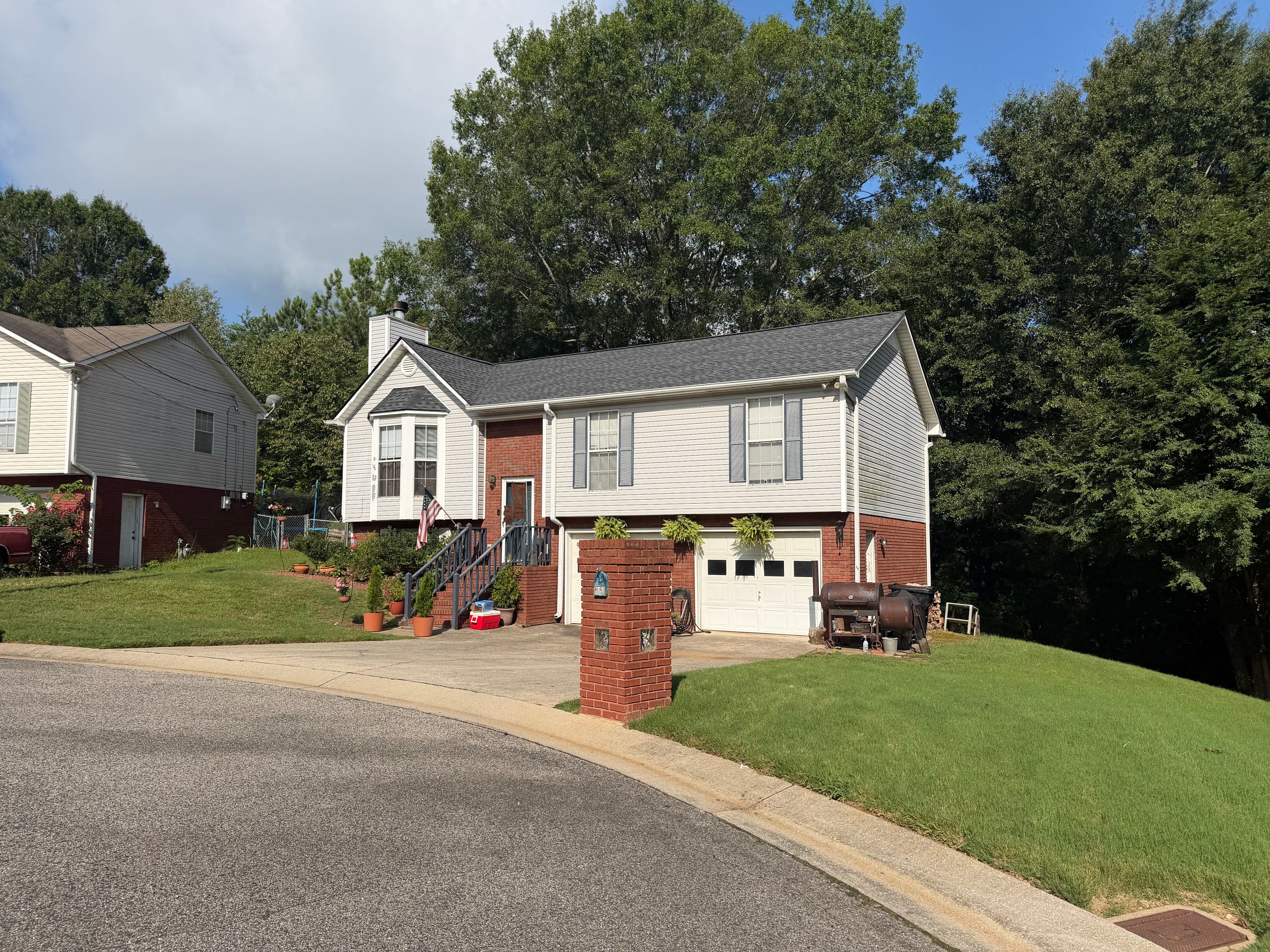A completed roof replacement on a brick-and-siding home in Pebble Lake, Birmingham.