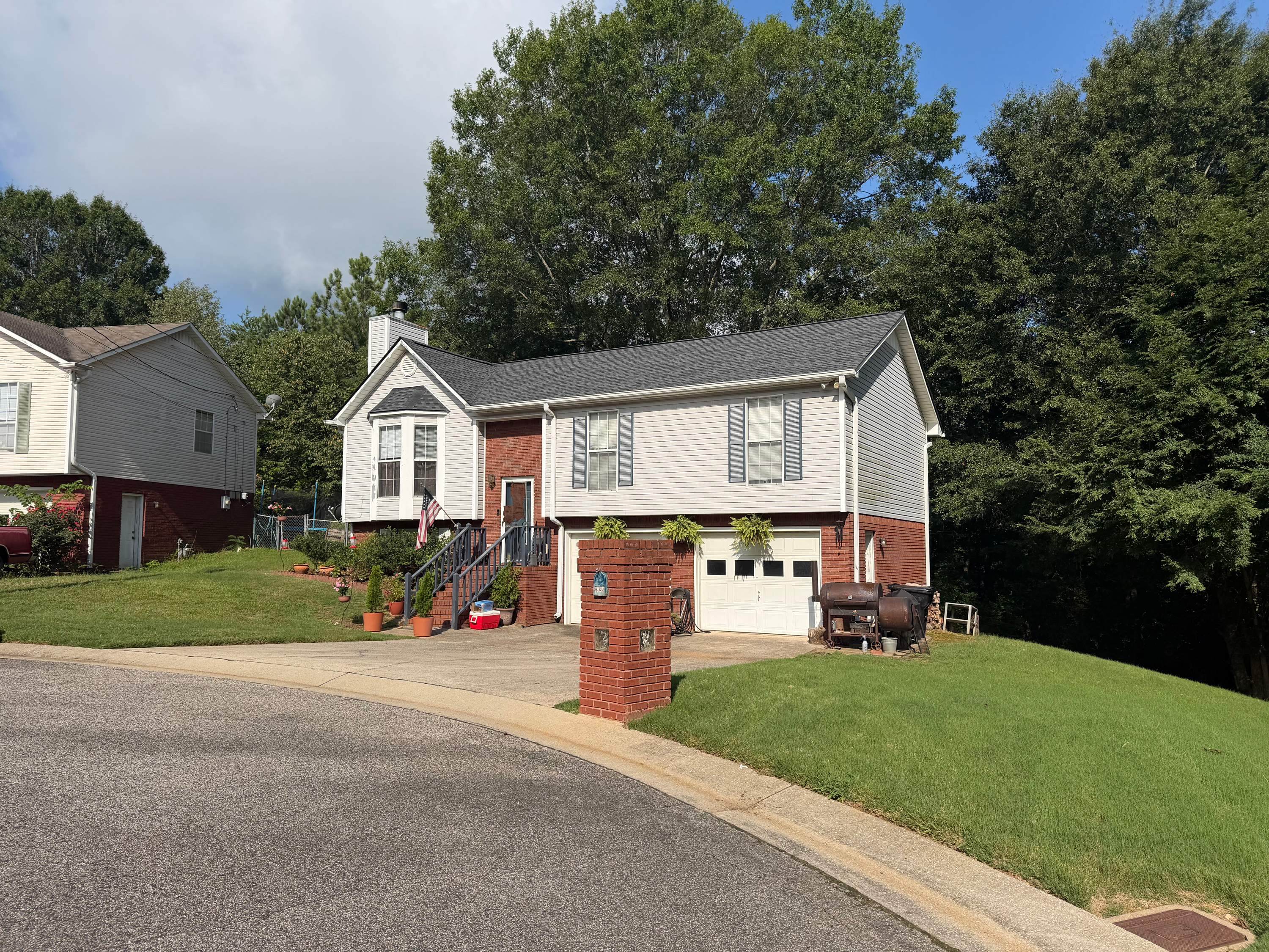 A completed roof replacement on a brick-and-siding home in Pebble Lake, Birmingham.