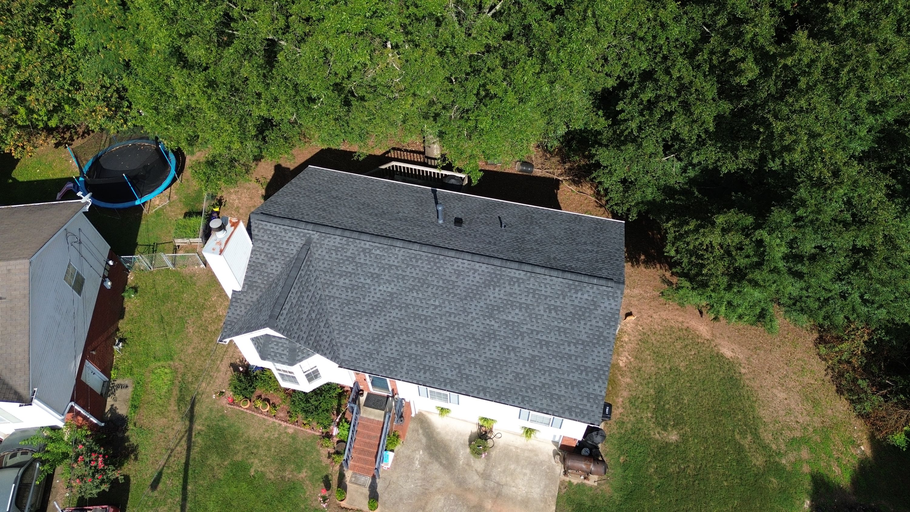 Looking down at a completed roof replacement in Pebble Lake, showing the finished shingles and vents.