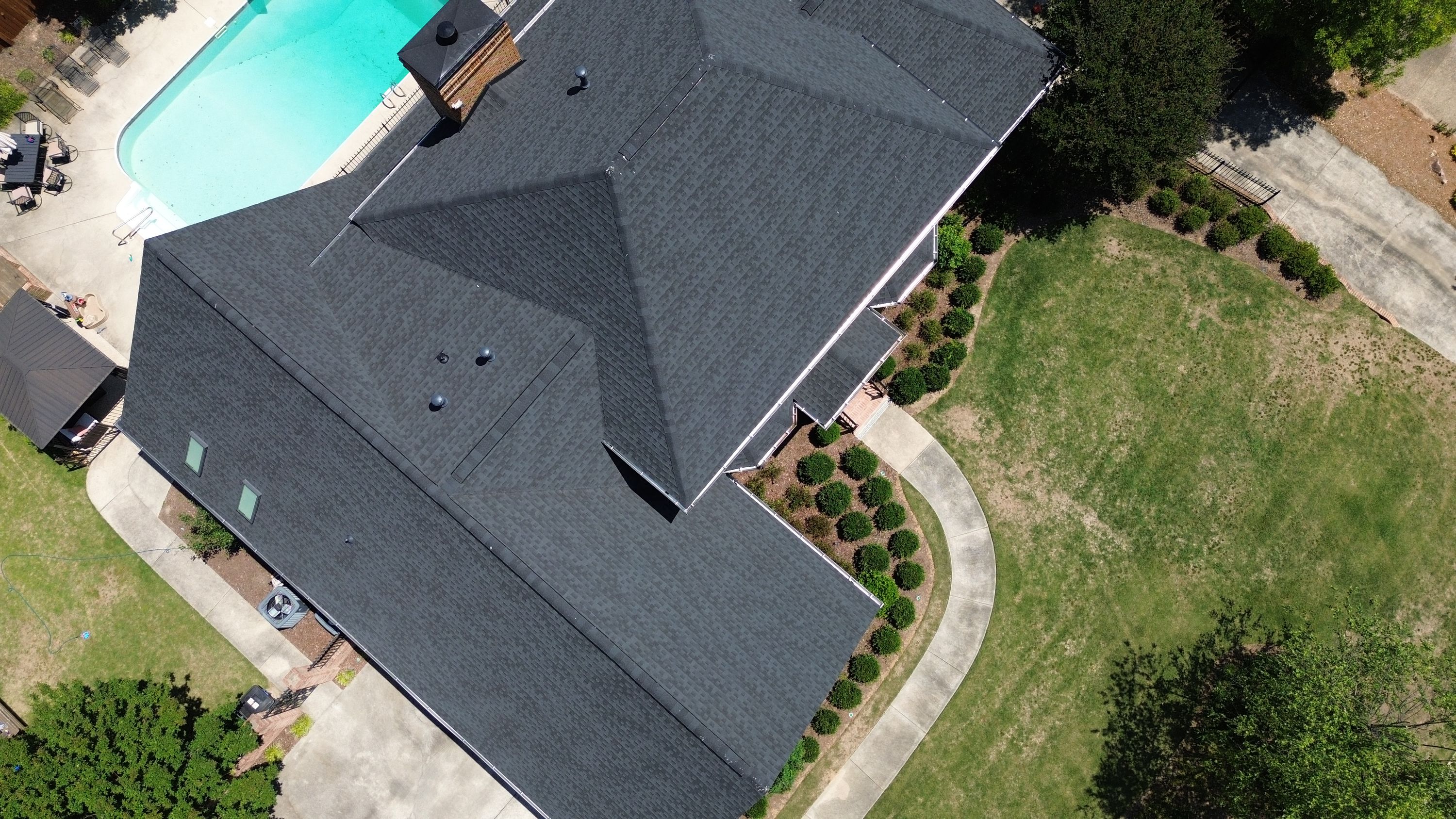 Aerial view of a completed asphalt shingle roof replacement on a home in the Carisbrooke neighborhood of Hoover.
