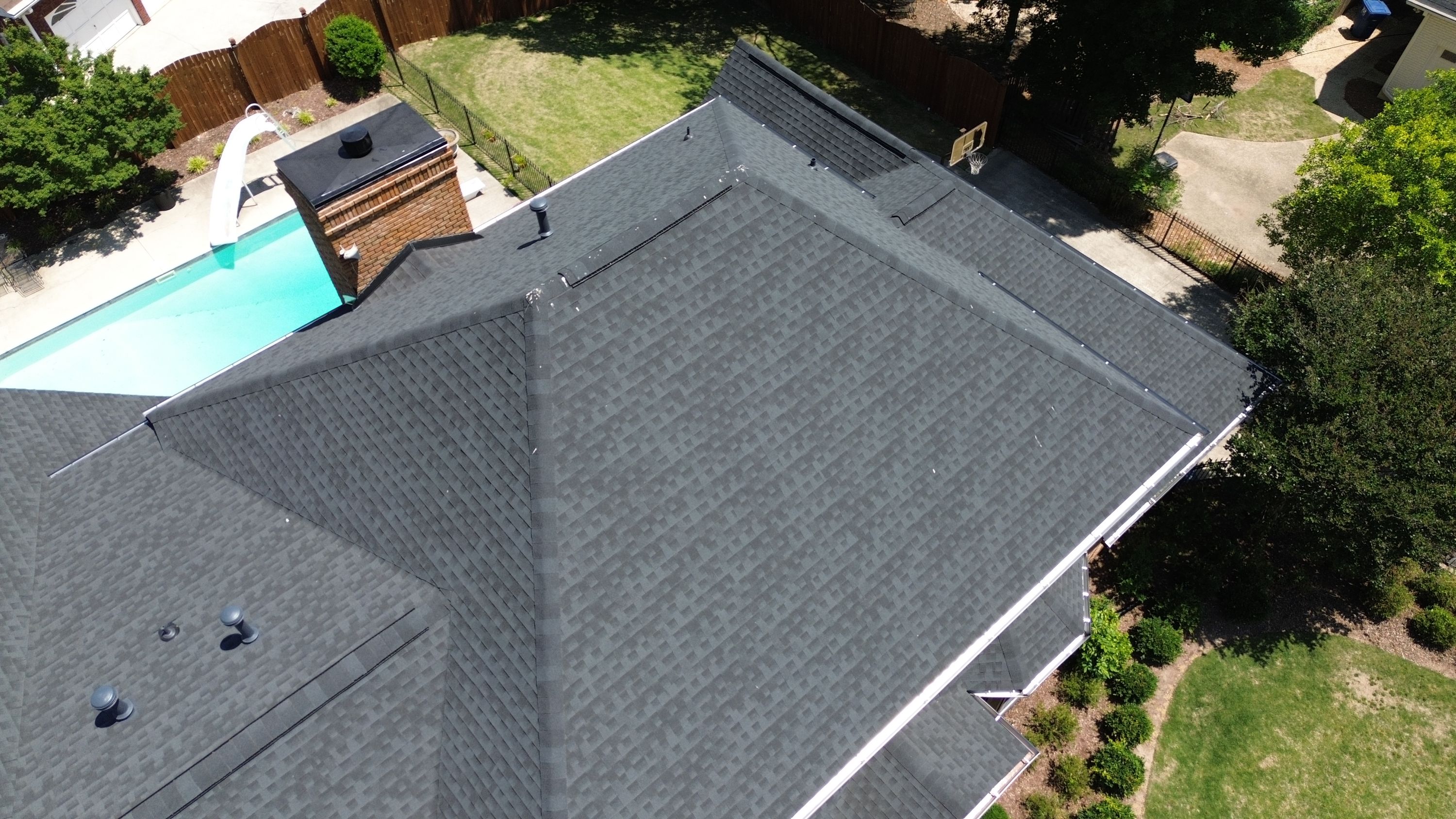 Aerial view of a completed roof replacement with dark architectural shingles on a home in Carisbrooke, Hoover.