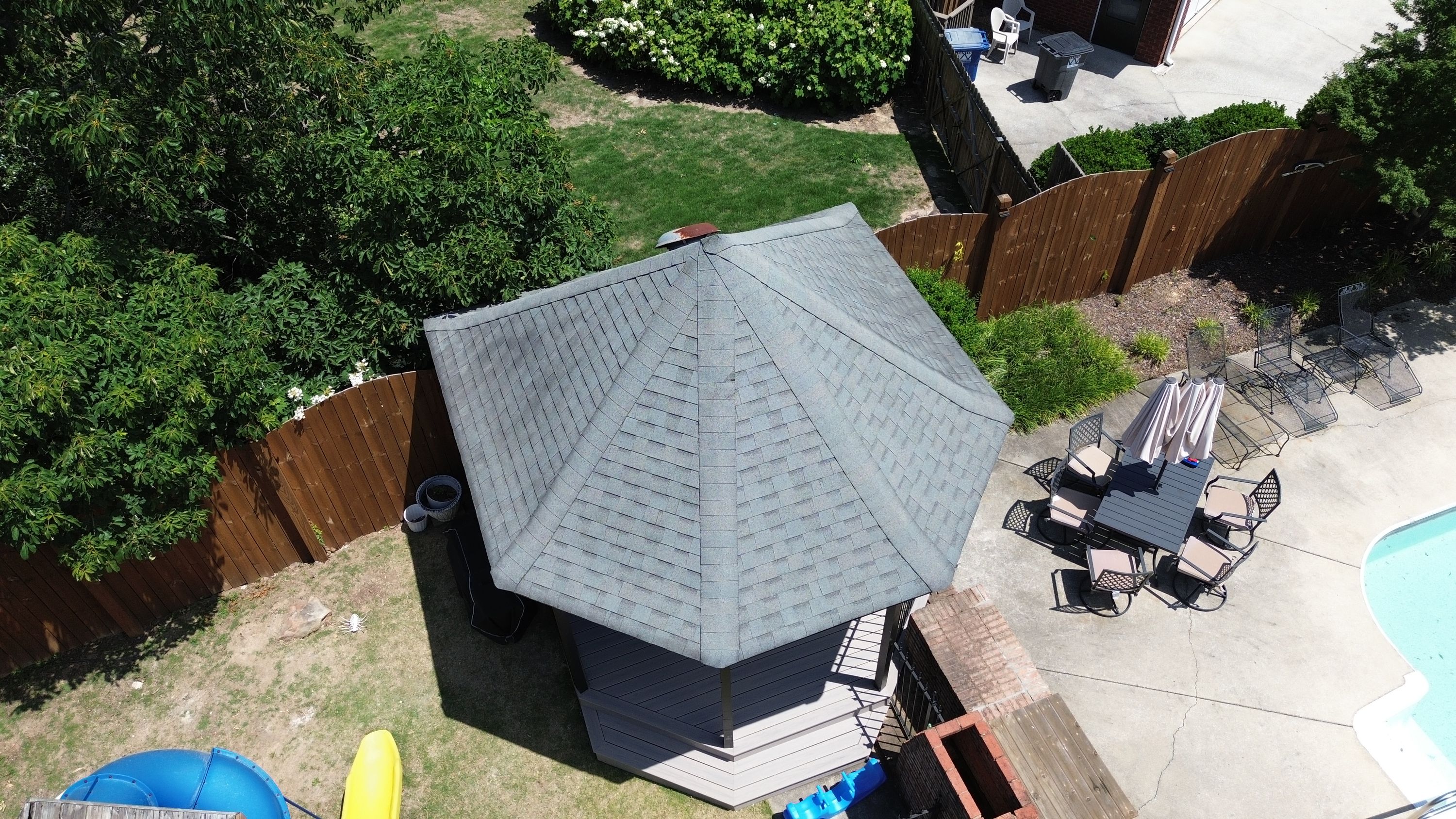 A newly installed gray asphalt shingle roof on a backyard gazebo in the Carisbrooke neighborhood of Hoover.