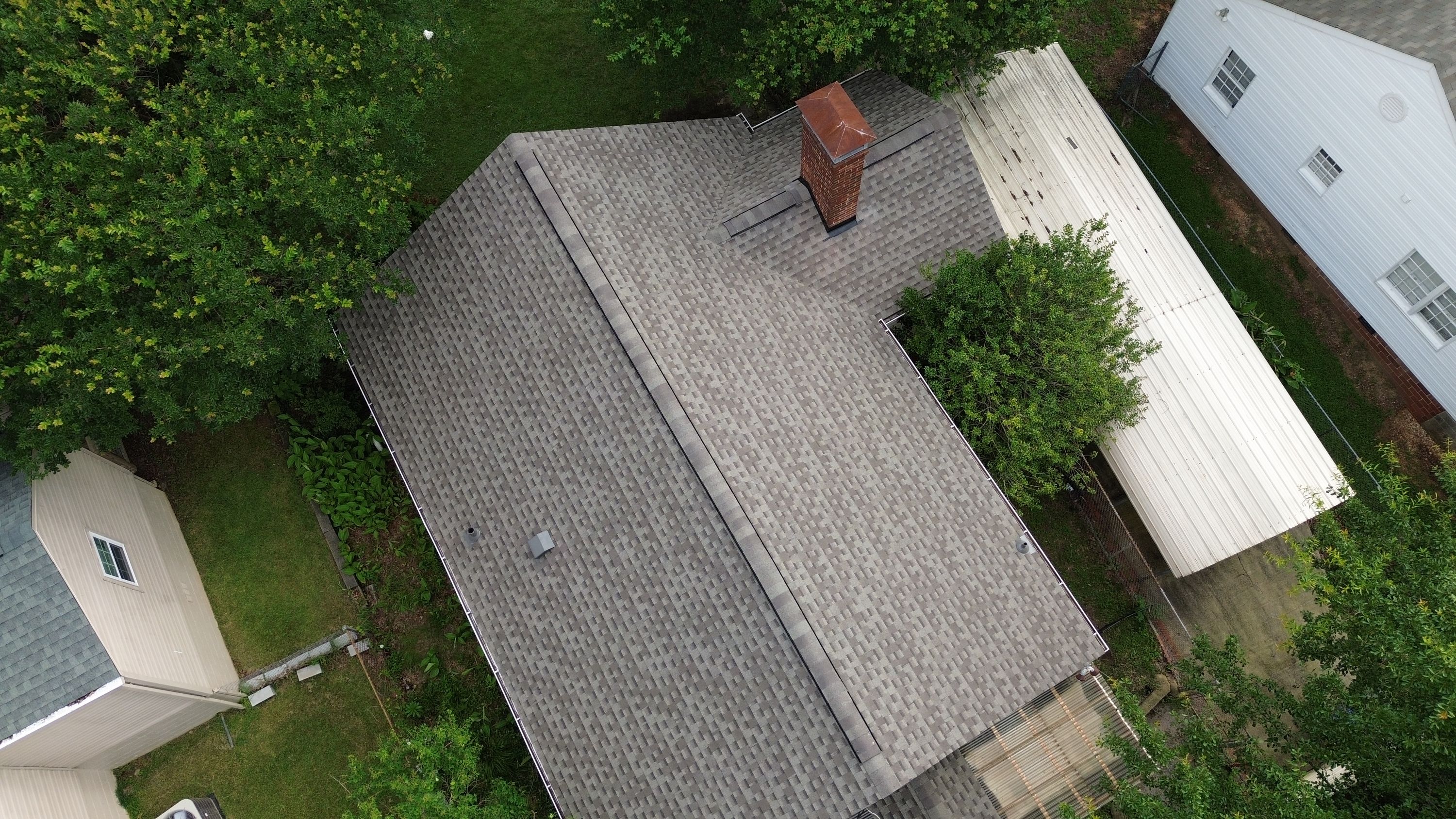 Aerial view of a completed asphalt shingle roof replacement on a home in Glen Iris, Birmingham.