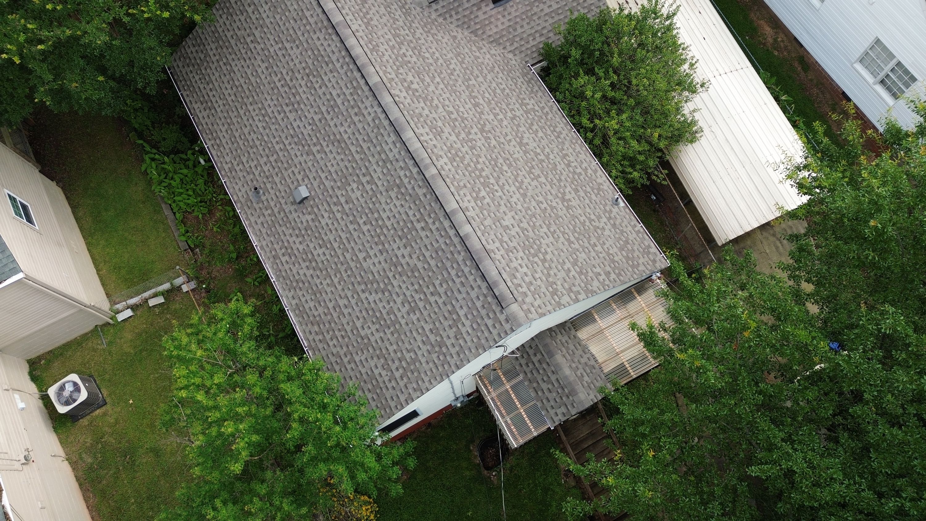 Aerial view of a completed gray asphalt shingle roof replacement on a home in Glen Iris, Birmingham.