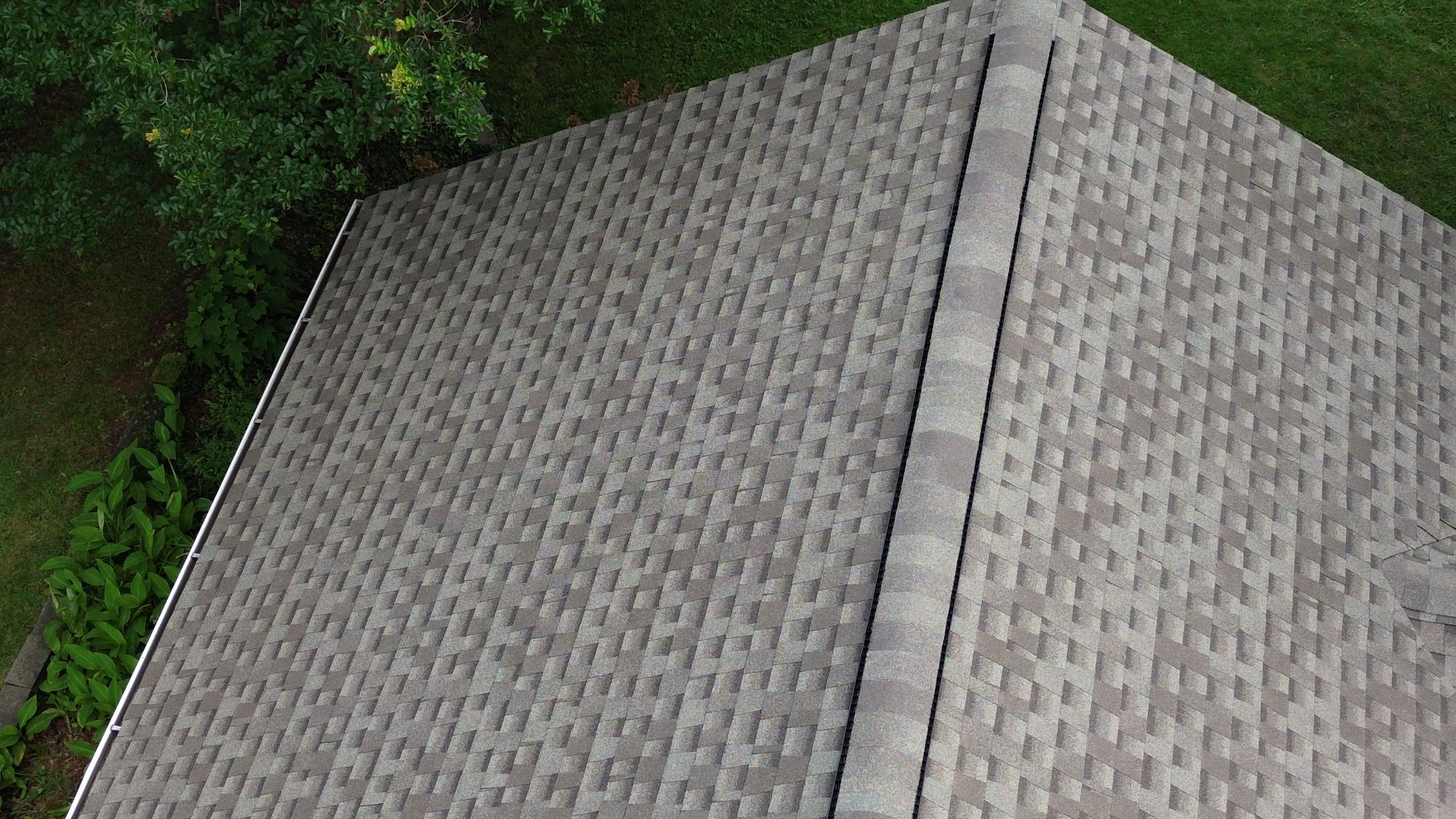 Newly installed gray architectural shingles and ridge vent on a home in Glen Iris, Birmingham.