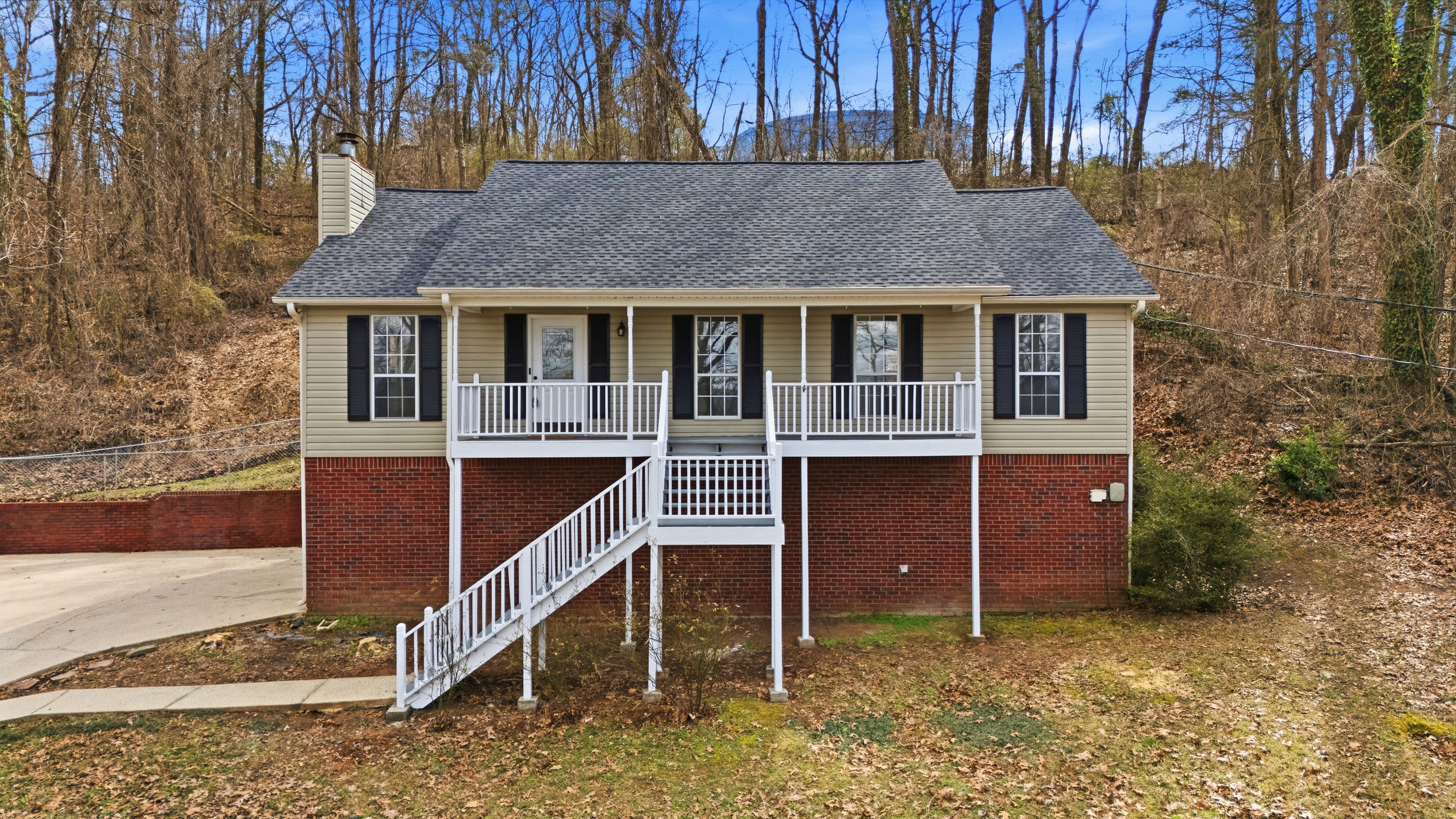 Front exterior of a home in Leeds, Alabama, showcasing a professional roof replacement with dark grey architectural shingles.