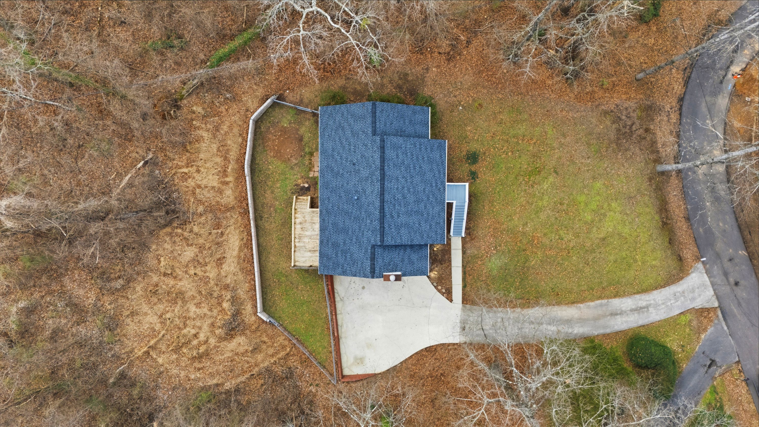 Overhead drone perspective of a high-quality roof replacement project in Leeds, Alabama, by Patriot Roofing & Builders.