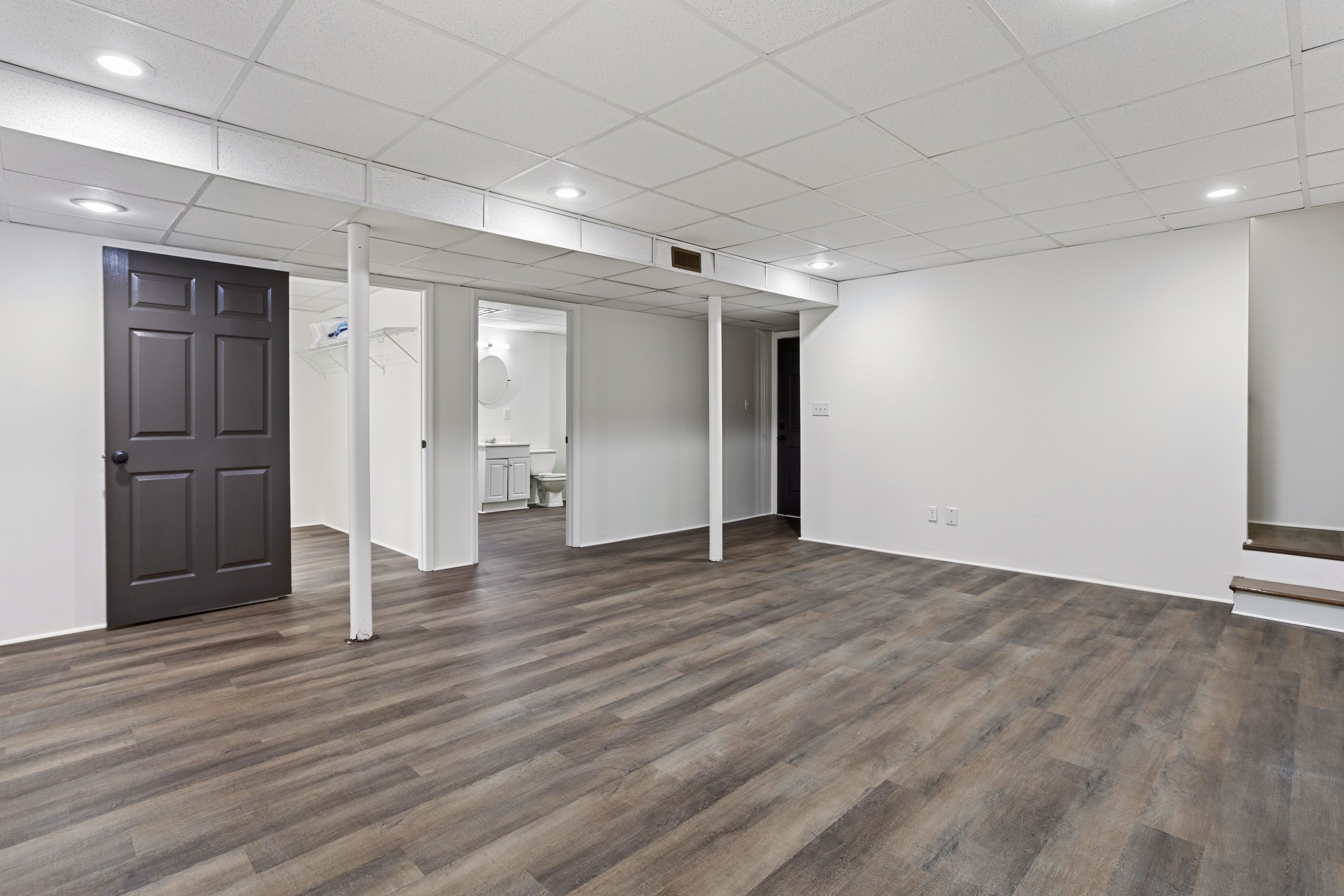 Renovated interior living area with modern grey flooring in a Leeds, AL home where we also performed roofing services.